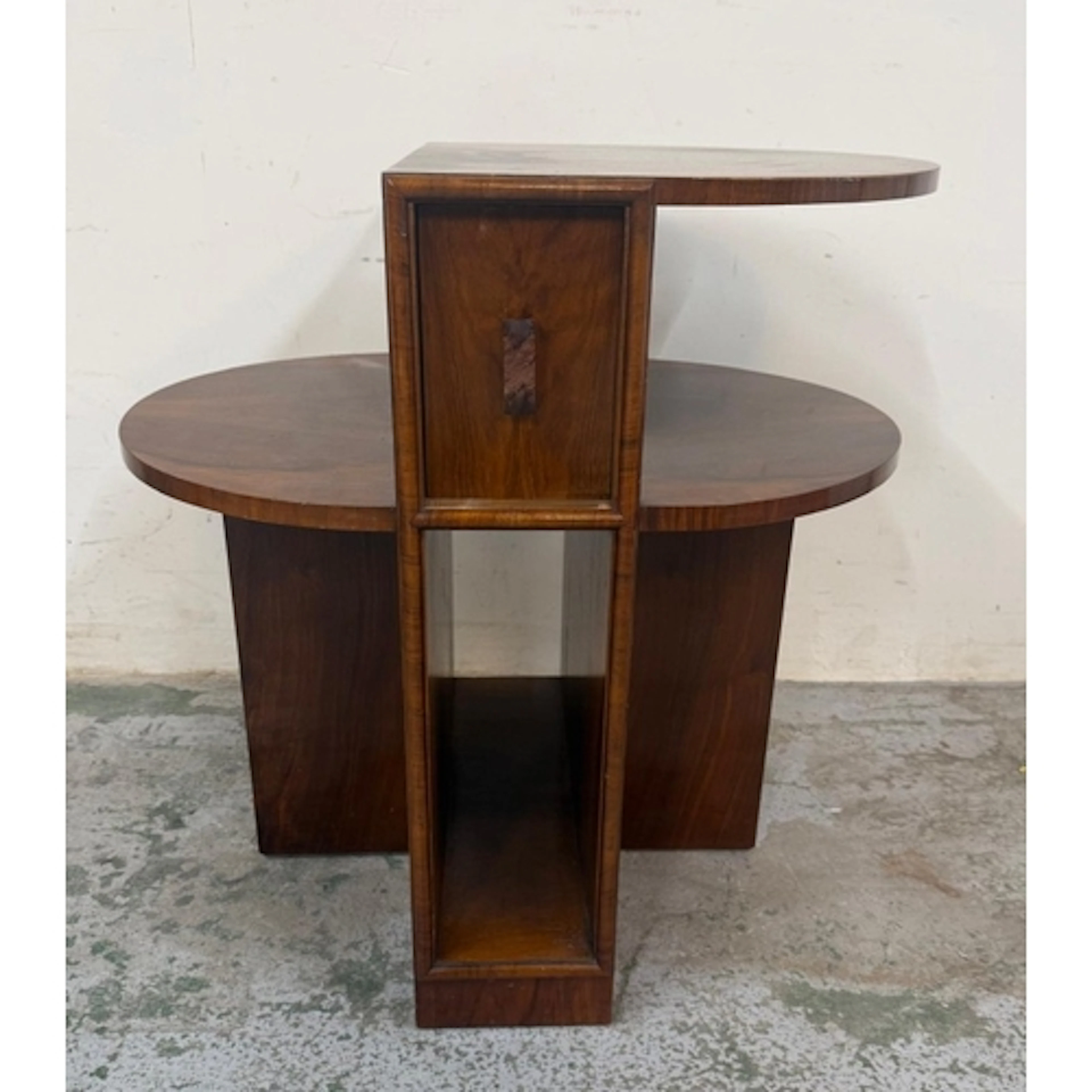 An Art Deco-style asymmetrical side table comprising two she...