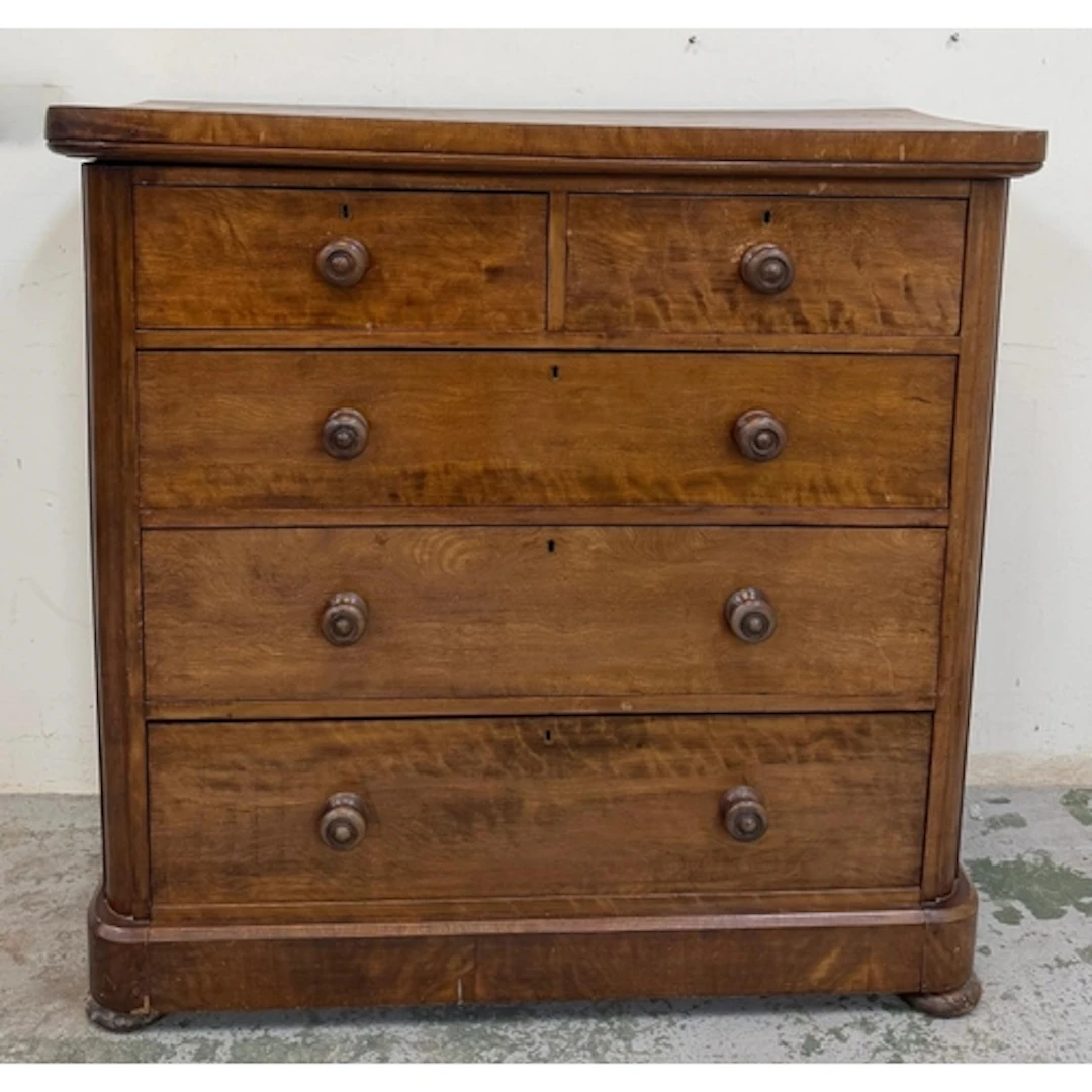 A two over three Edwardian chest of drawers with turned hand...