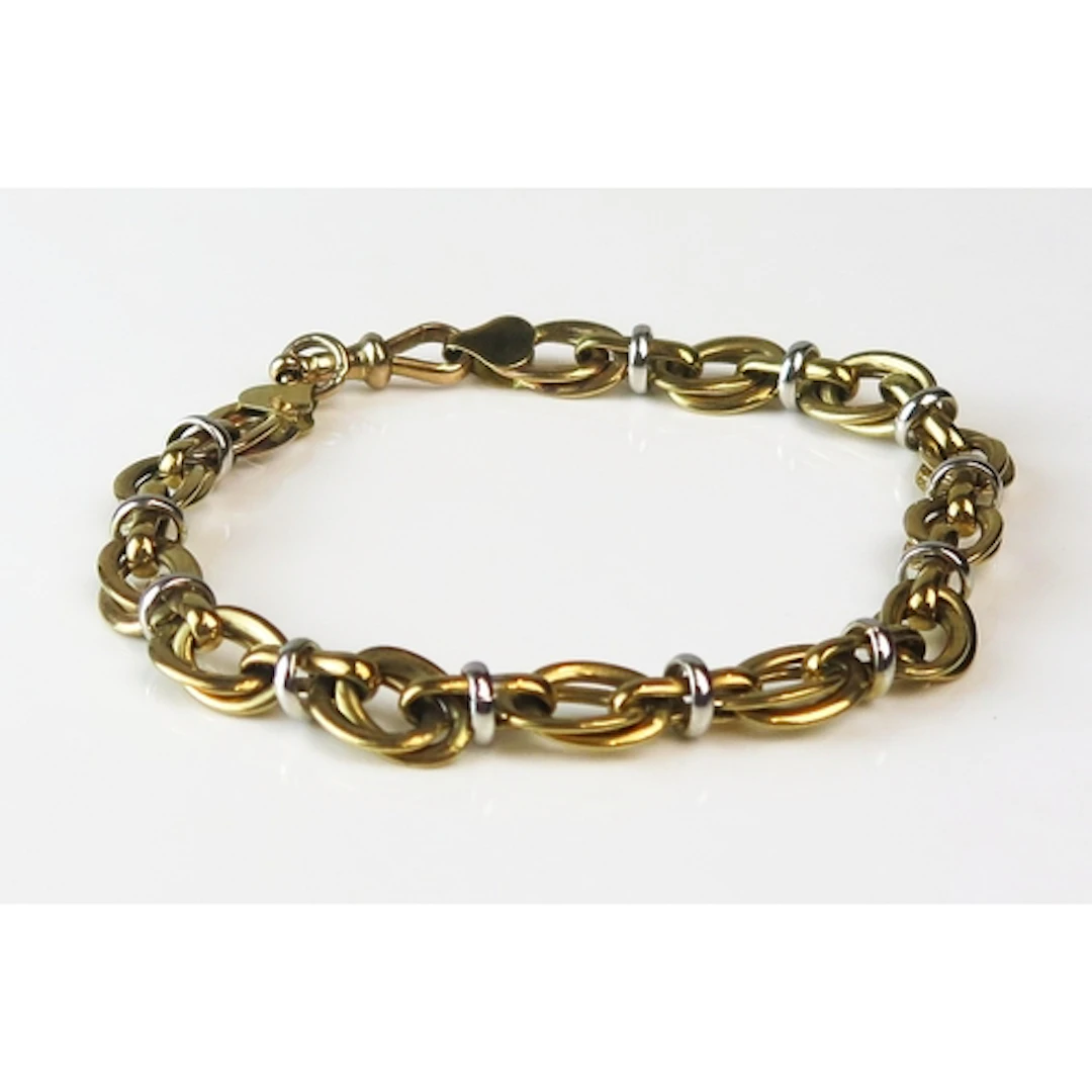 A 9ct yellow and white # gold fancy link bracelet, 23cm long...
