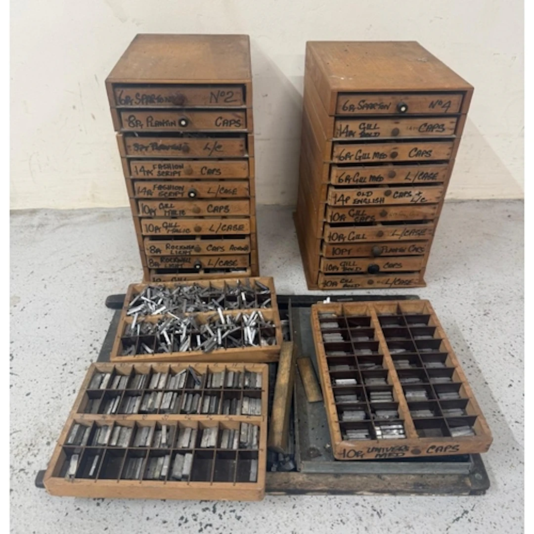 Two sets of printers drawers and a large quantity of typeset...