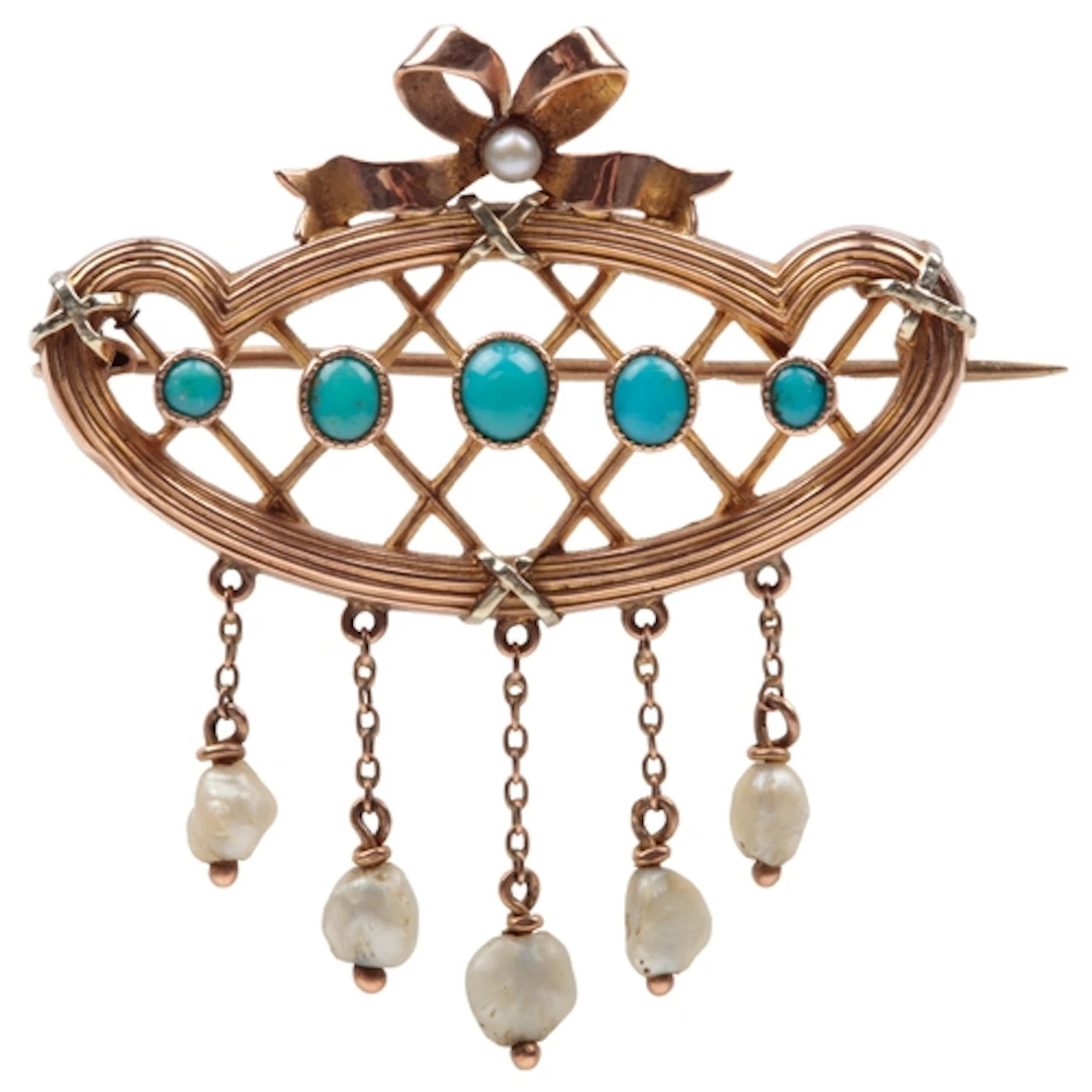 A turquoise and pearl brooch, circa 1900, centring on a line...