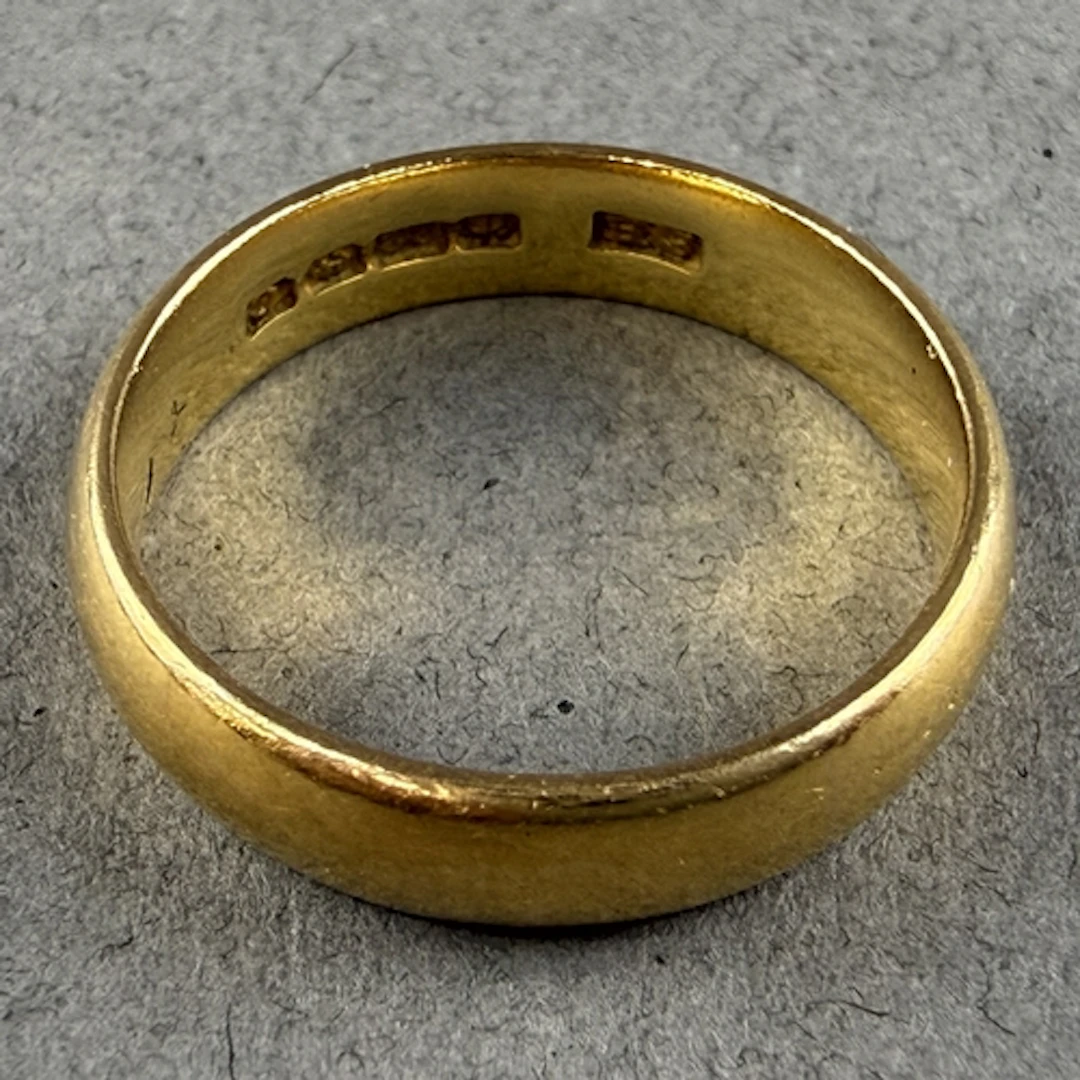 Jewellery: a 22ct yellow gold wedding band, Birmingham 1927,...