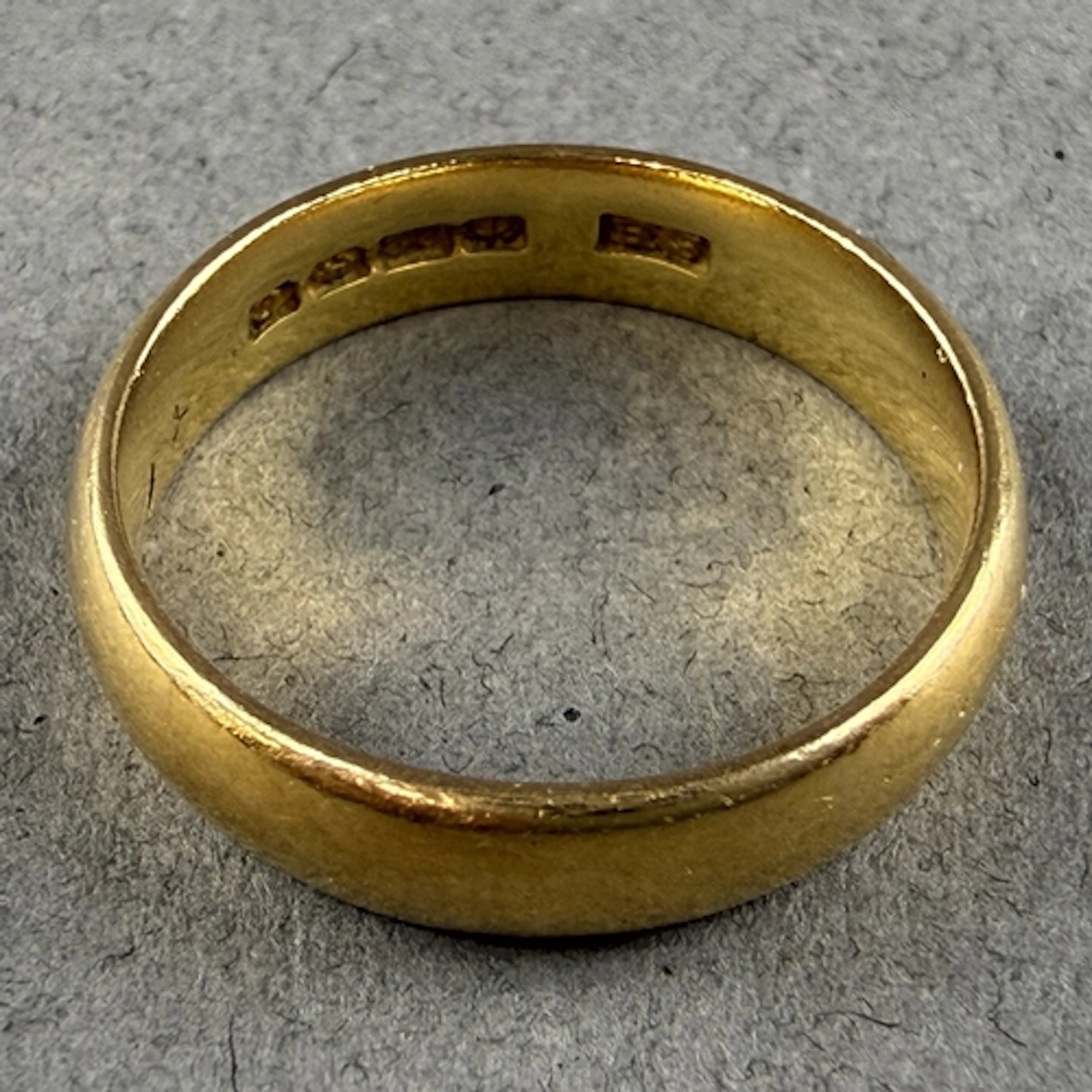 Jewellery: a 22ct yellow gold wedding band, Birmingham 1927,...