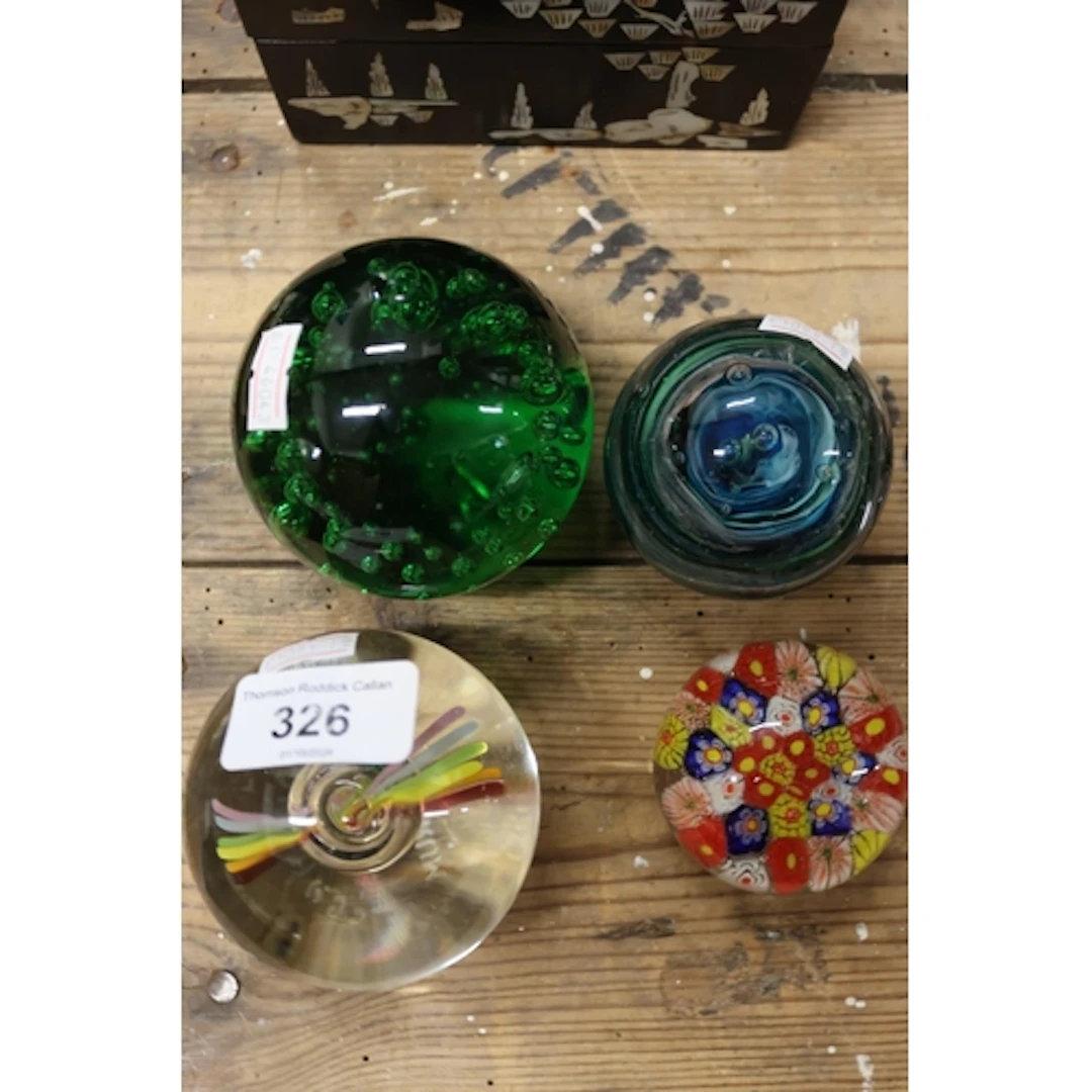 Four art glass paperweights.