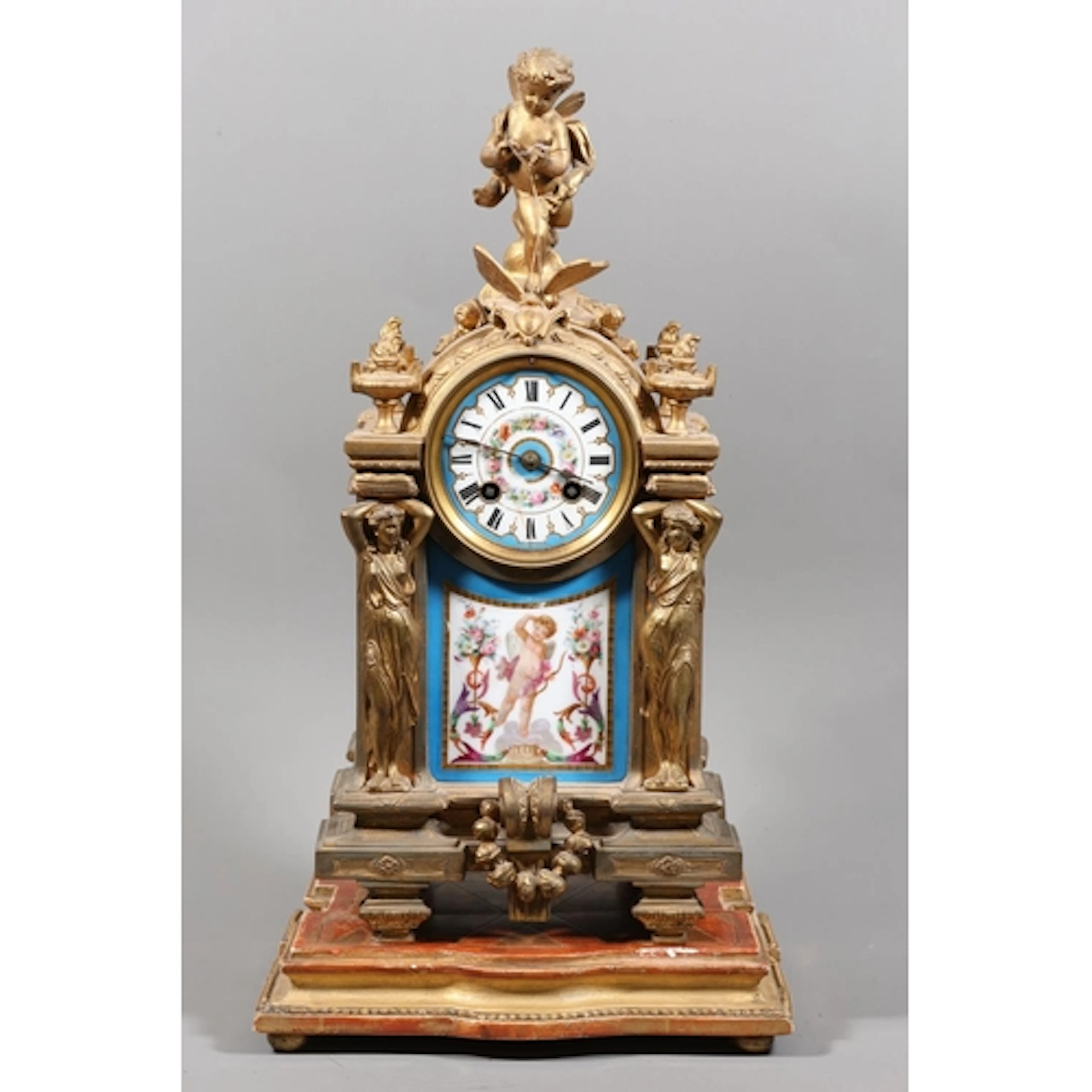 Continental mantel clock mounted by cherub and butterfly, ci...