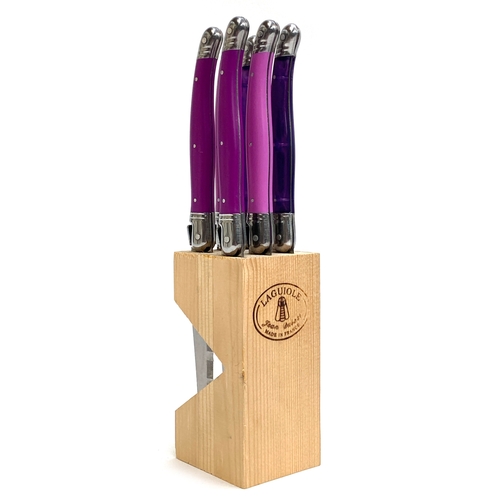 A set of six Laguiole steak knives with colourful handles in...