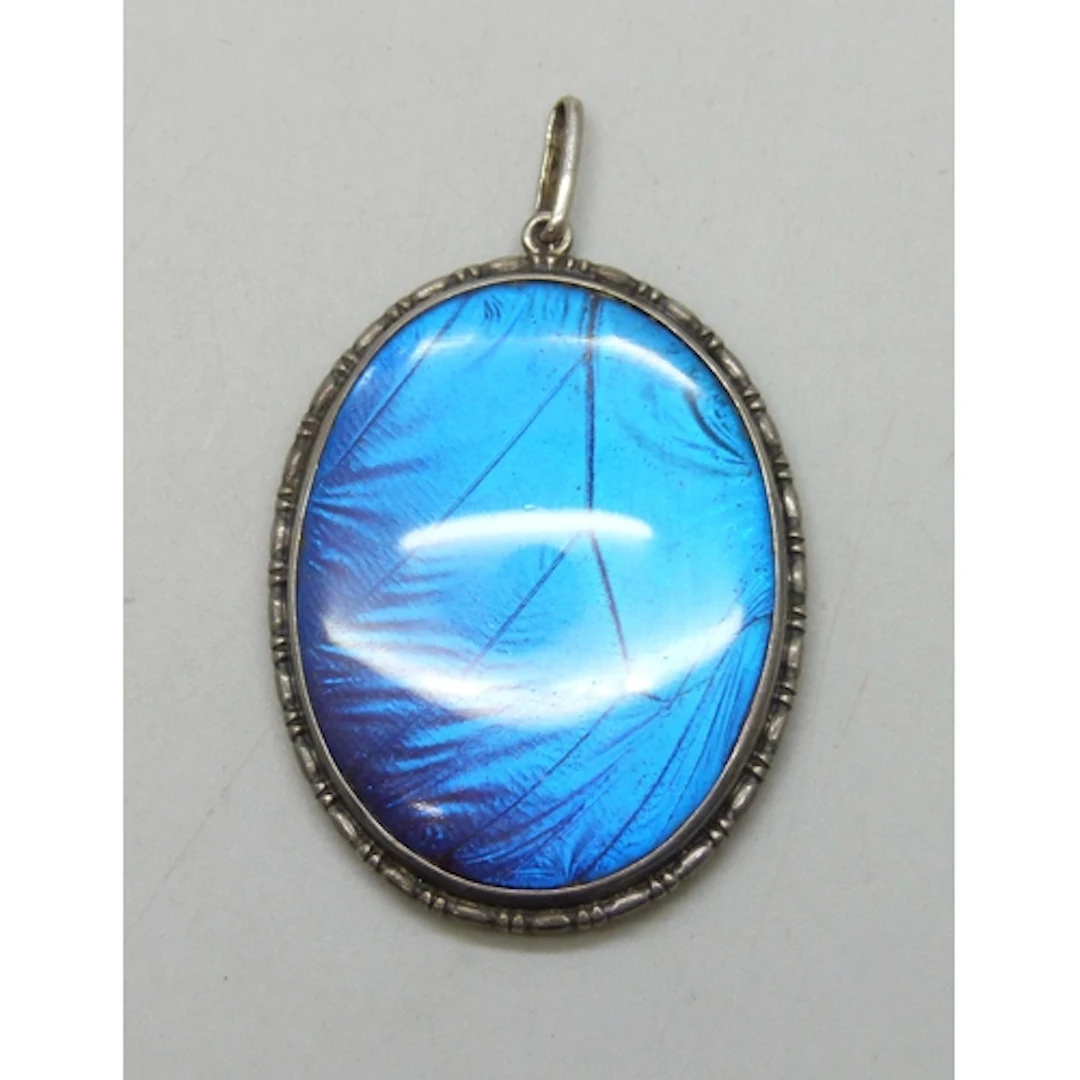 A large Art Deco statement silver and butterfly wing pendant...