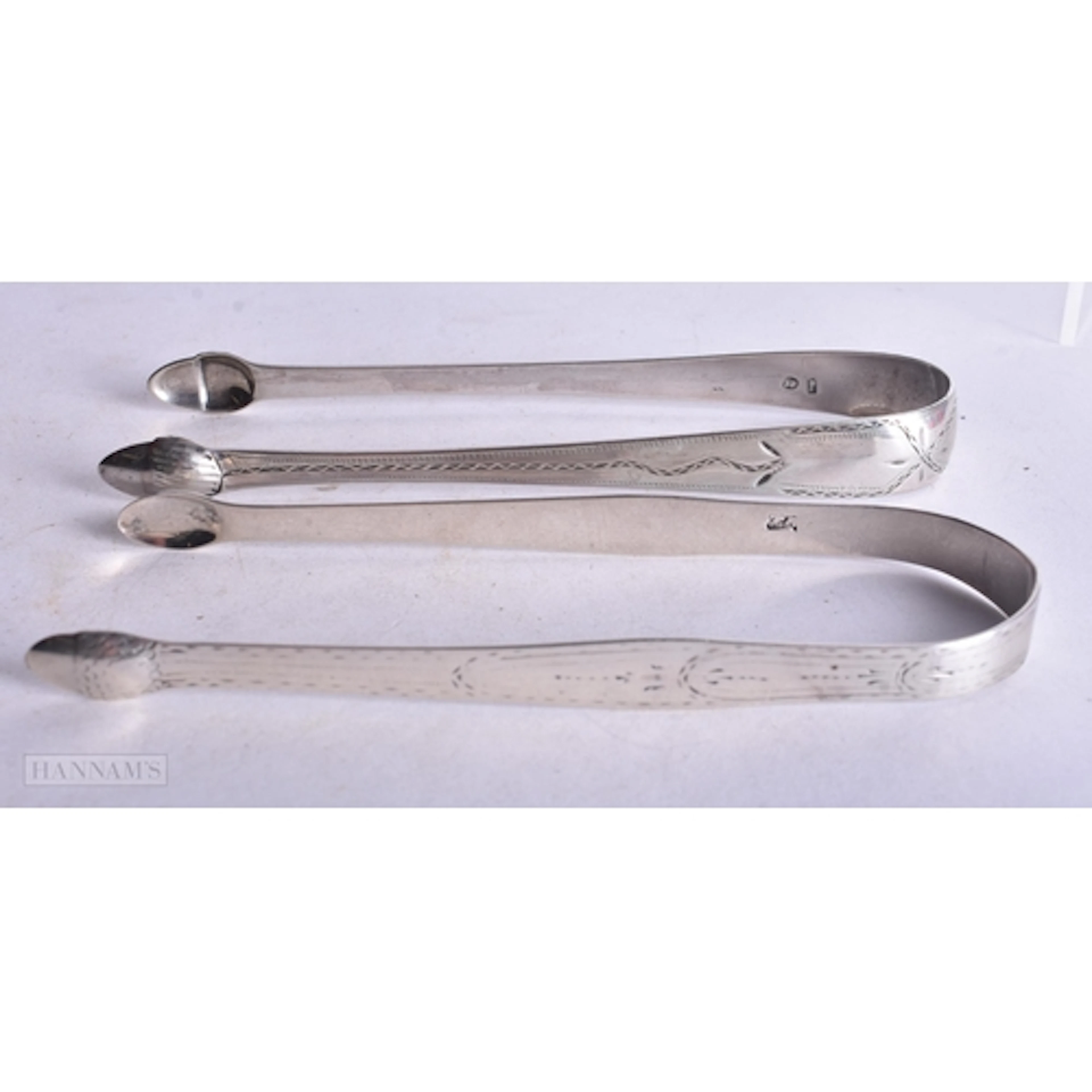 TWO PAIRS OF ANTIQUE SILVER SUGAR TONGS. 59 grams. 14 cm lon...