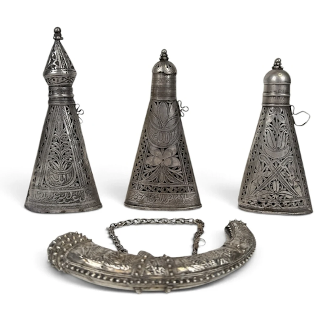 THREE OMAN SILVER SWORD SHEAF FITTINGS Together with a powde...