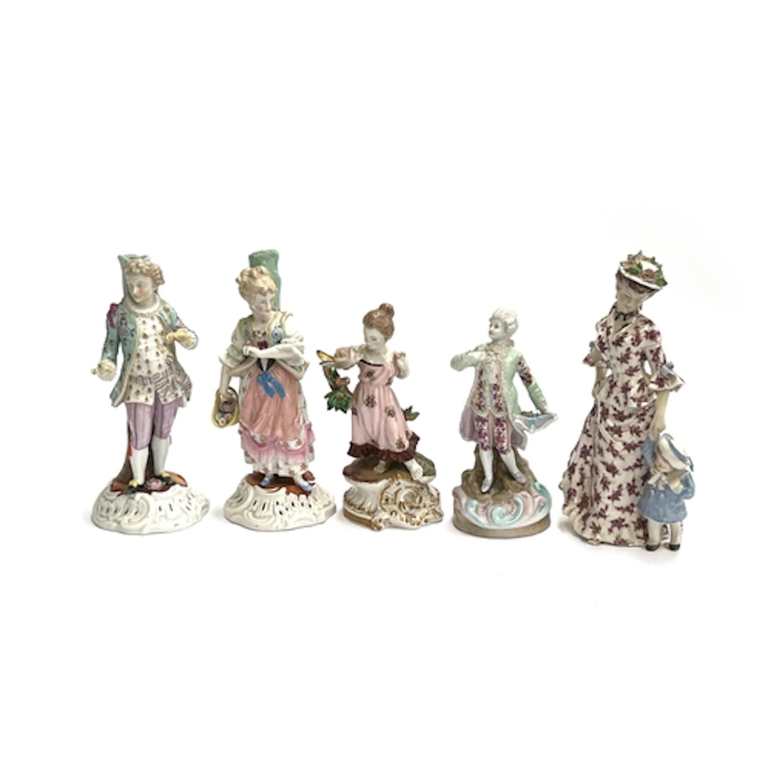 A pair of German porcelain figurines of a lady and gentleman...