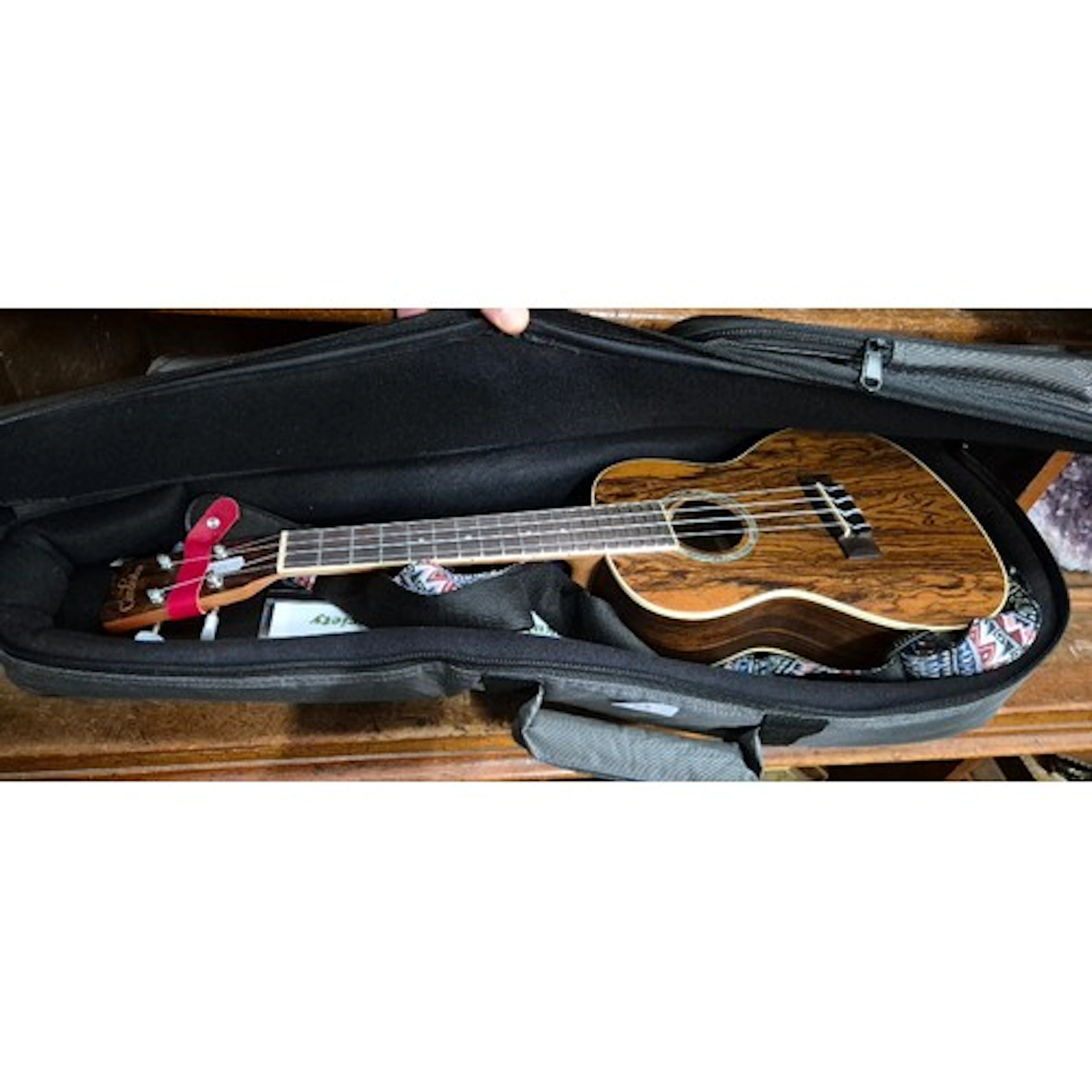 A Ukelele by Cordoba model 15CB, with music stand