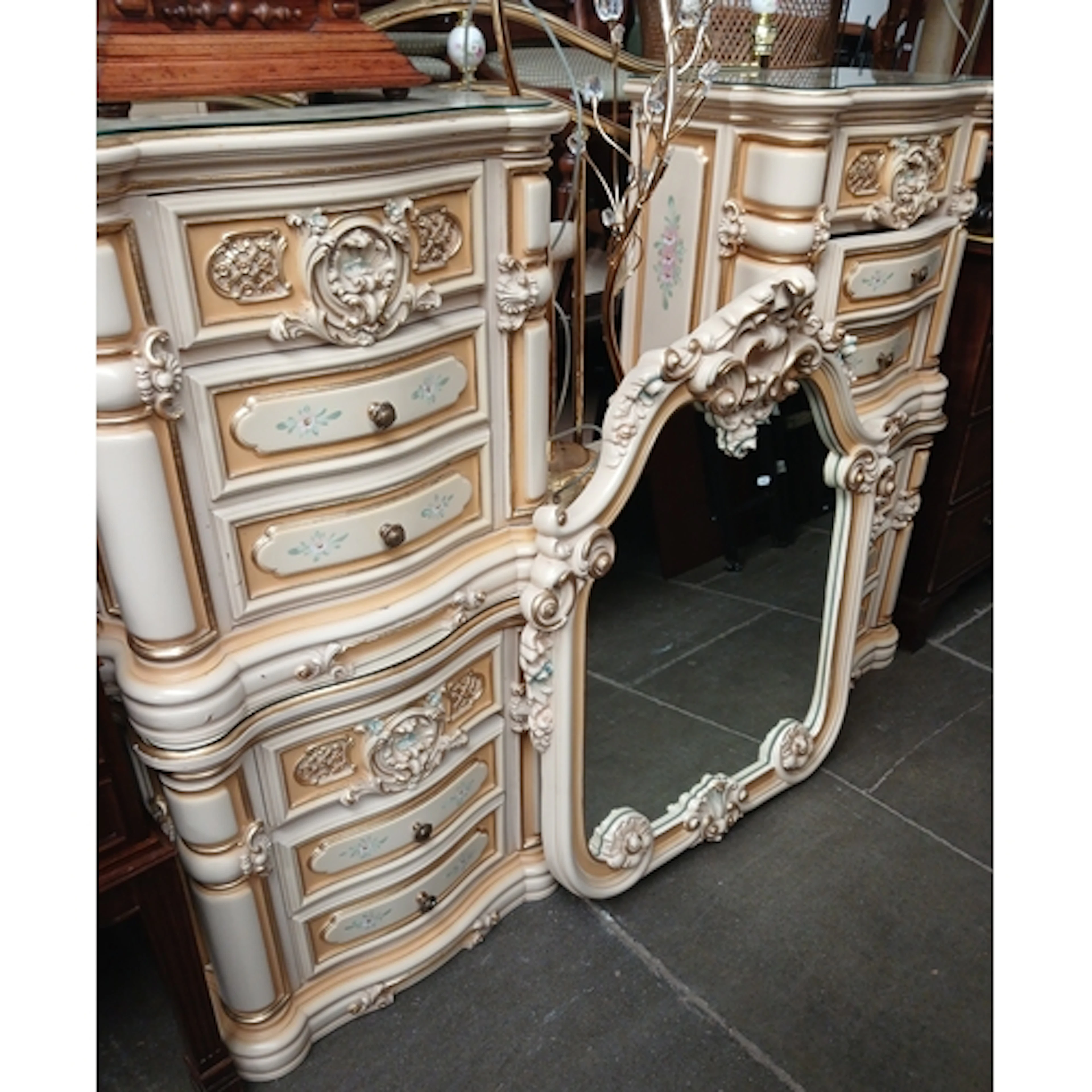 A suite of cream and floral decorated bedroom furniture comp...