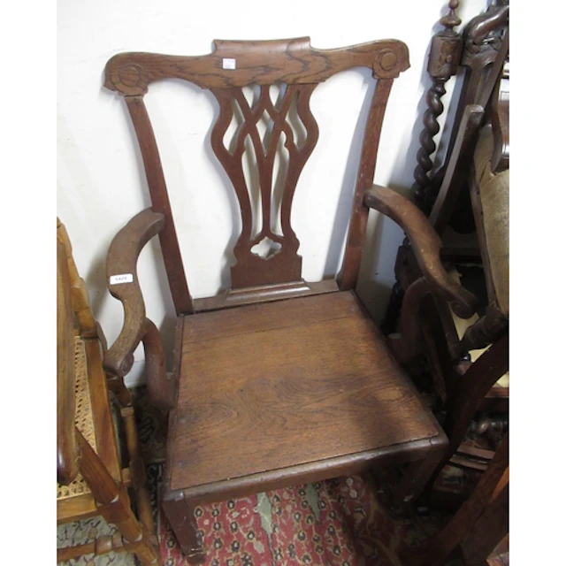 George III oak pierced splat back open elbow chair, together...