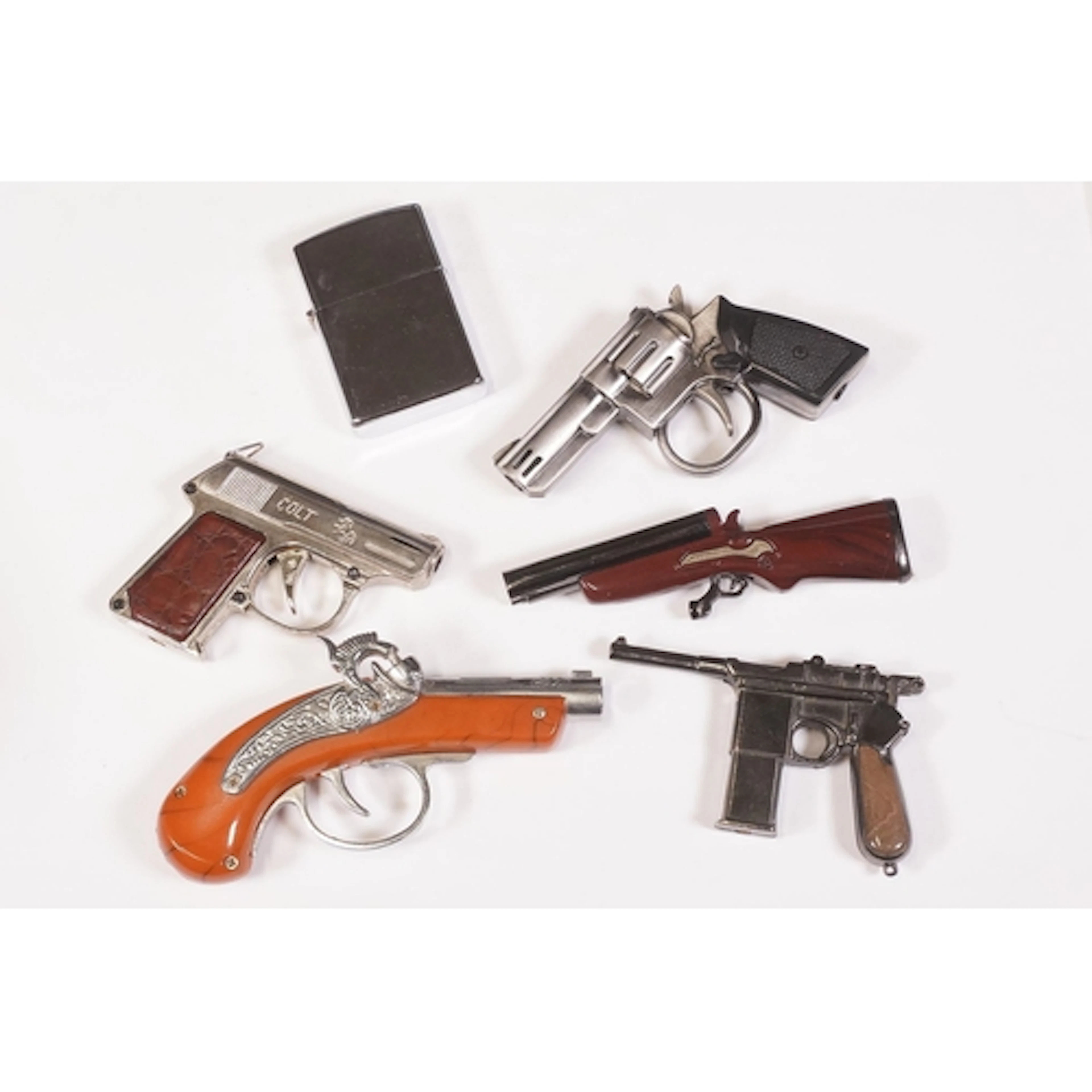 Five novelty lighters in the form of guns to include example...