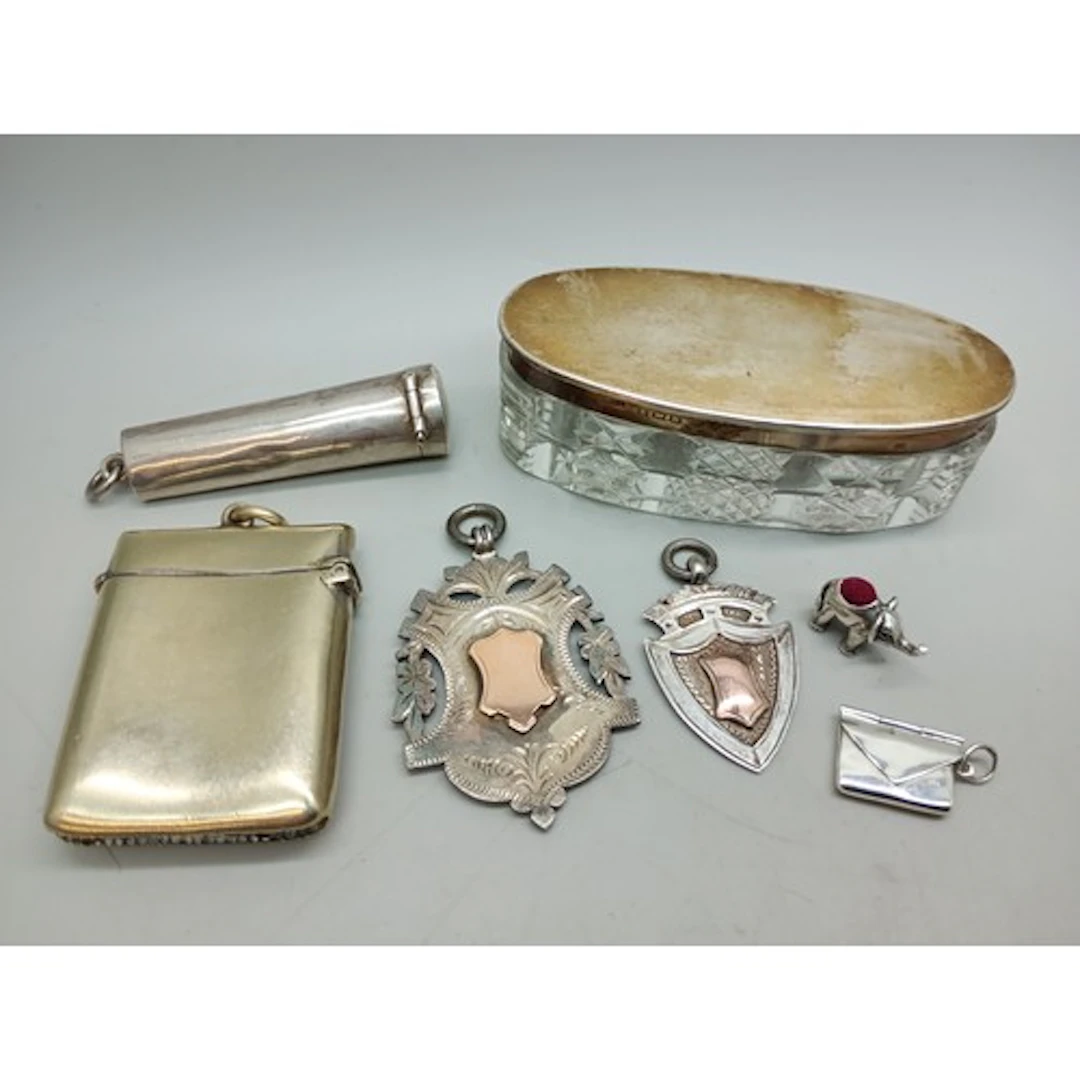 A collection of silver - a silver lidded pot, a silver chero...