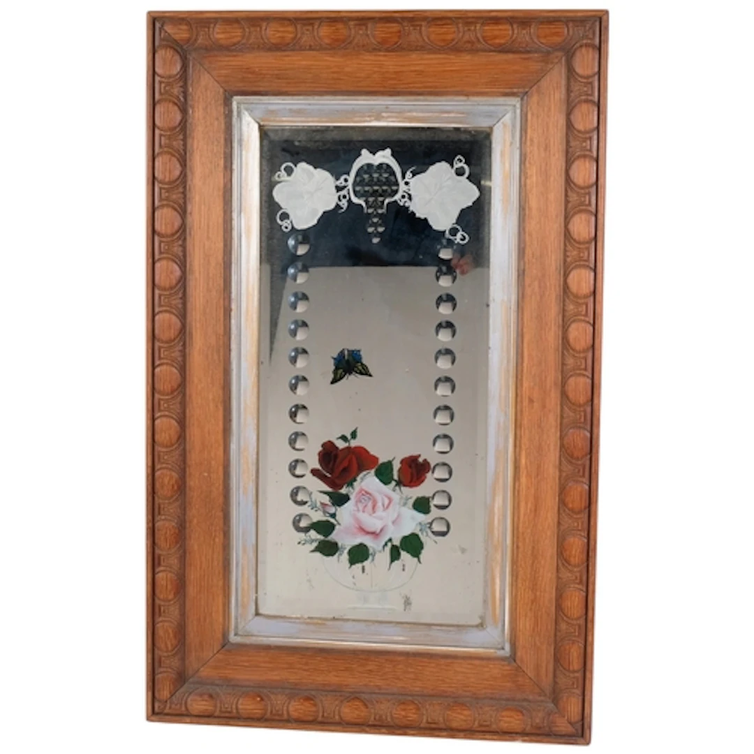 An early 20th century wall mirror, reverse painted and etche...