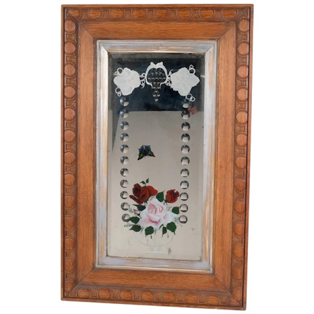 An early 20th century wall mirror, reverse painted and etche...