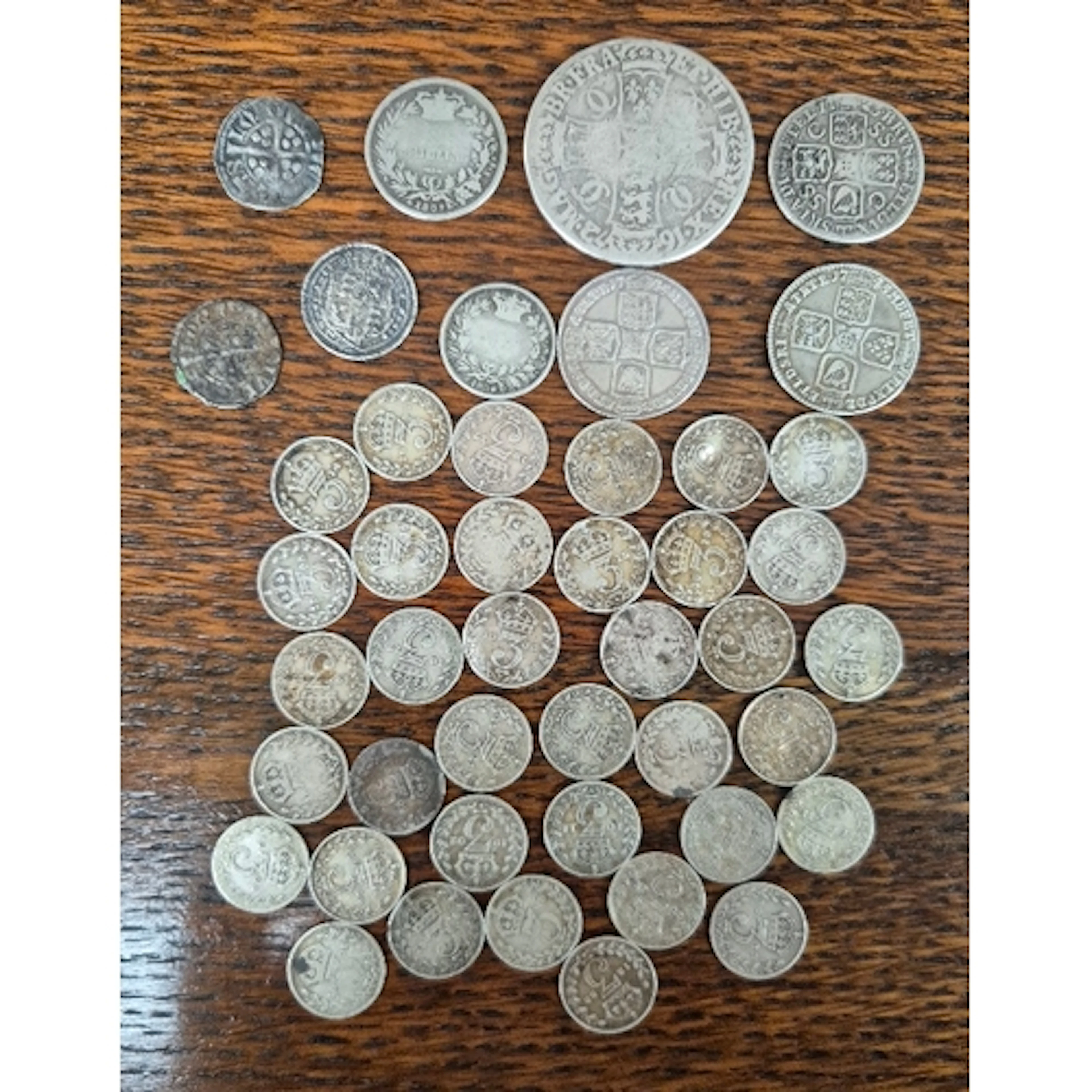 A group of assorted silver coins to include two hammered Edw...