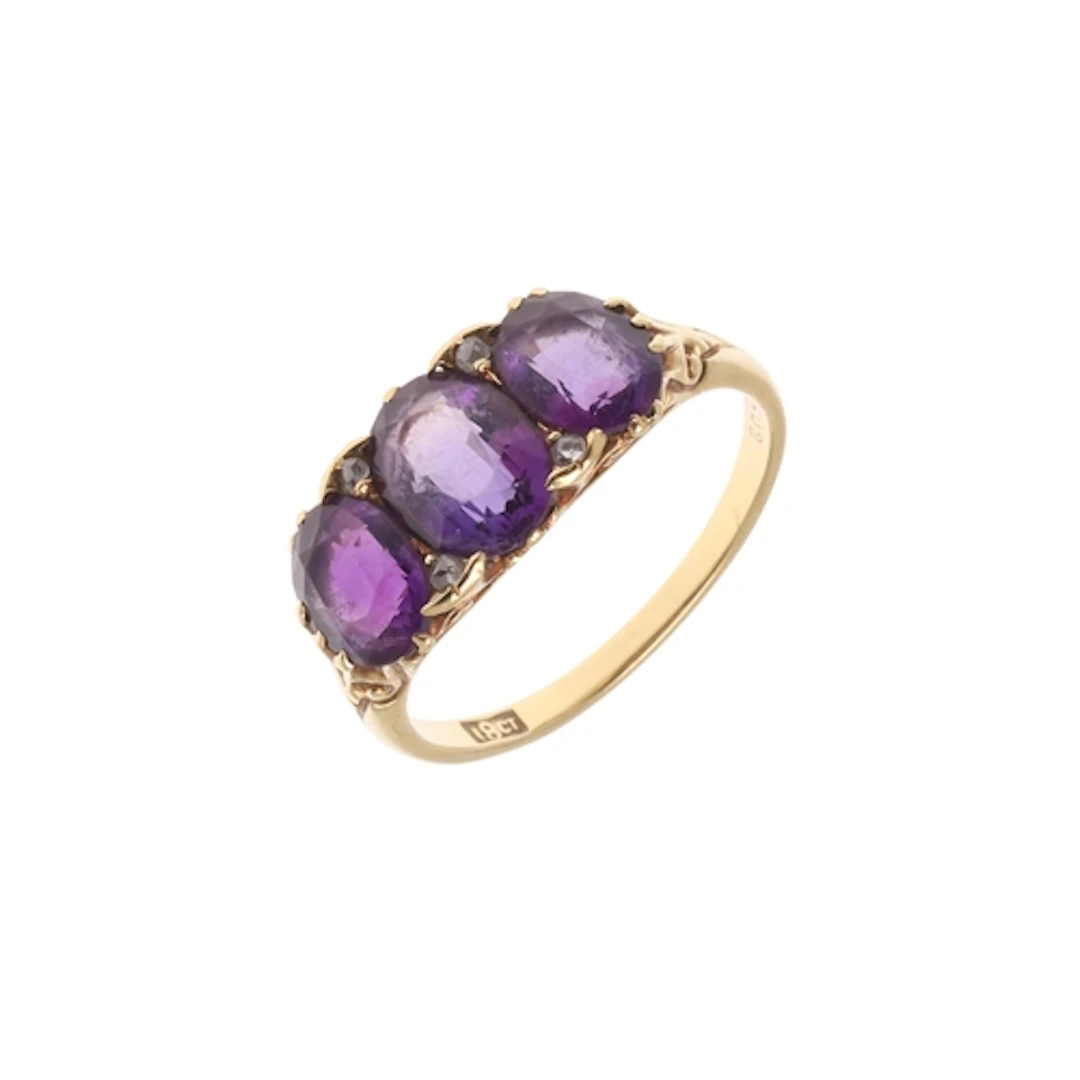 AN AMETHYST AND DIAMOND RING. the three oval-shaped amethyst...
