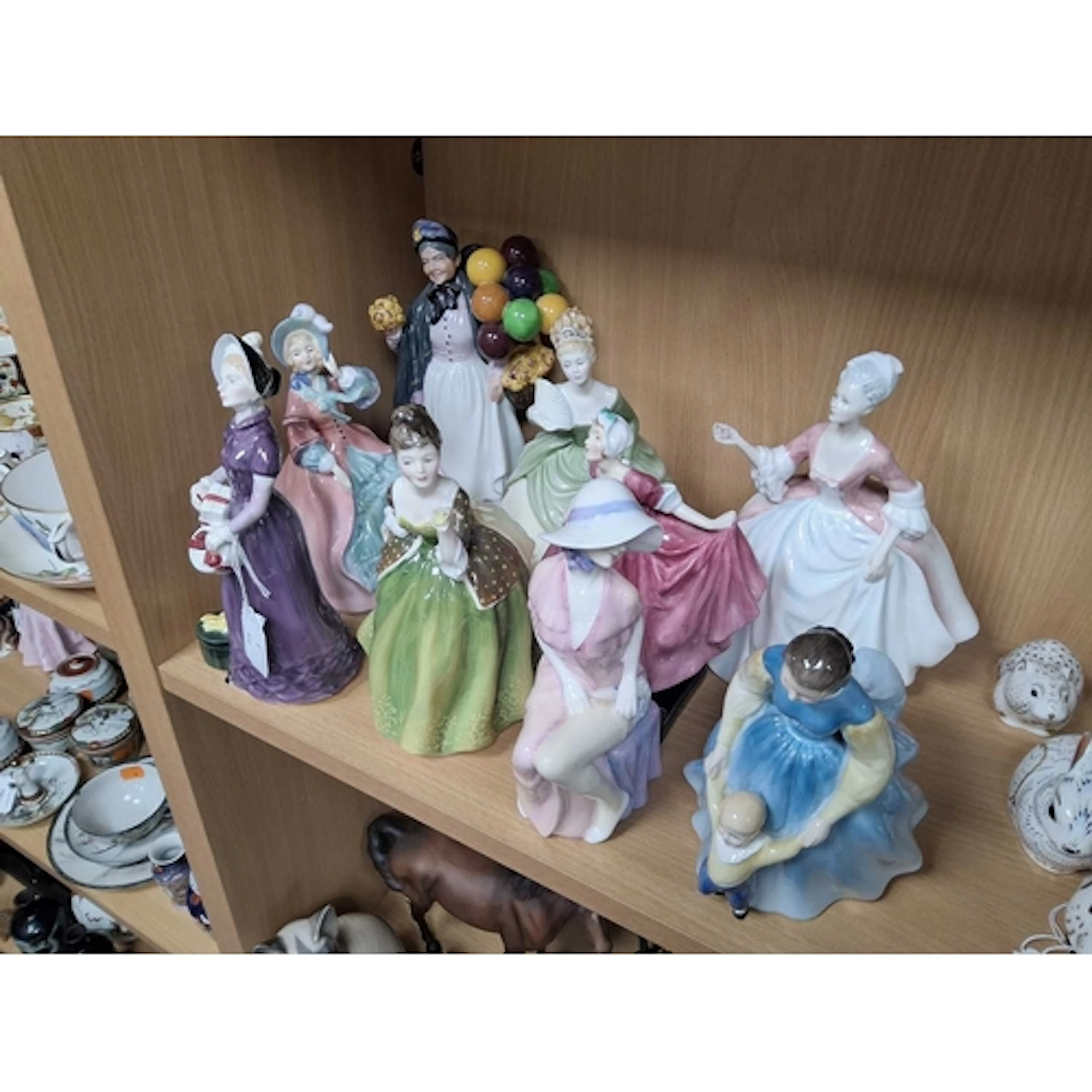 A GROUP OF NINE ROYAL DOULTON PORCELAIN LADY FIGURES compris...