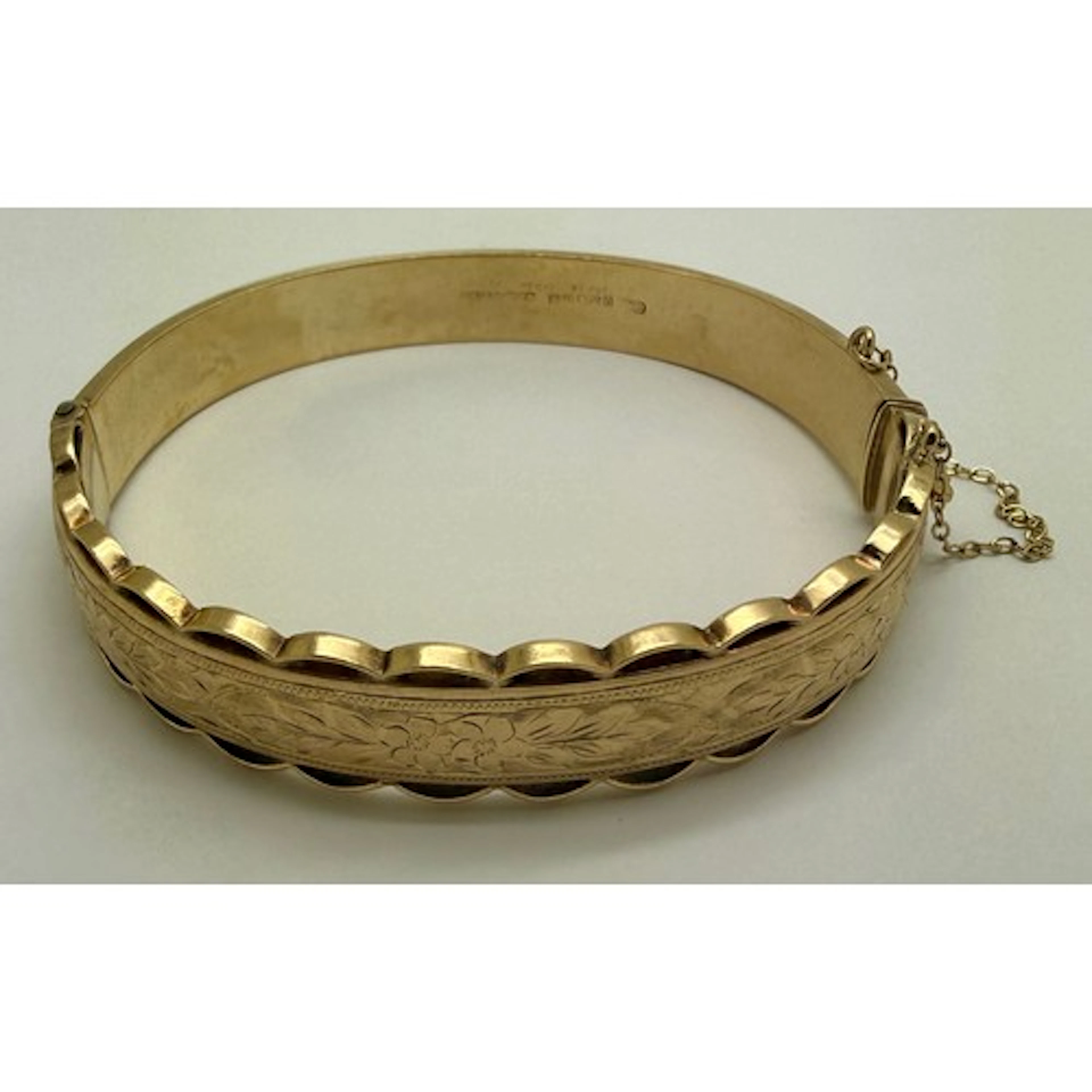 A 9 carat gold hinged bangle, internal measurement 6cm x 5.5...