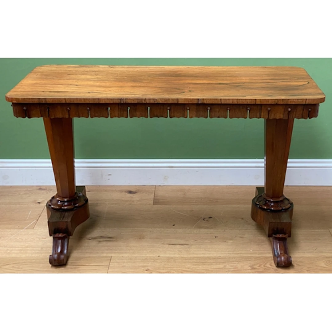 A Victorian rosewood centre or library table with shaped apr...