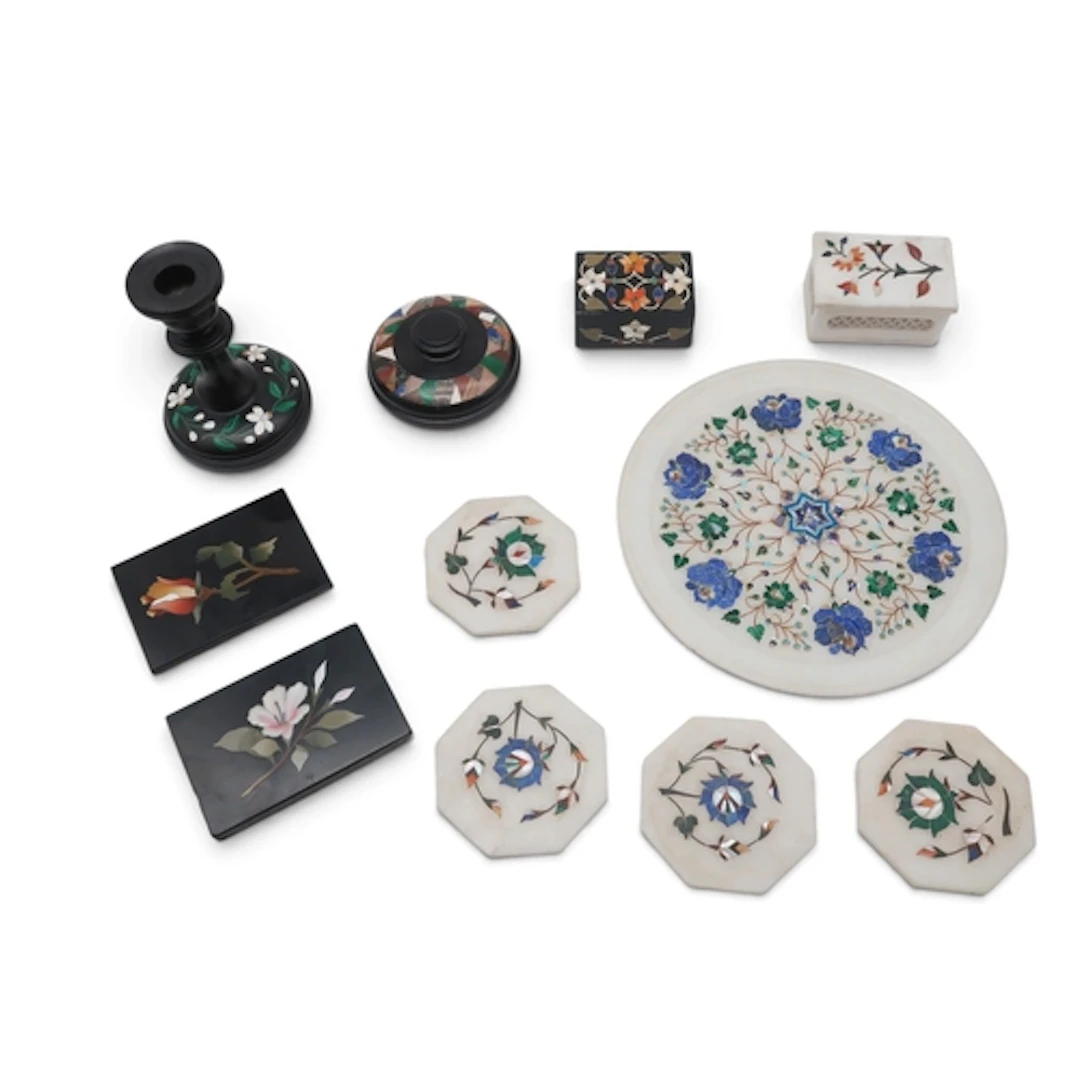 A group of pietra dura including a candlestick, paperweights...