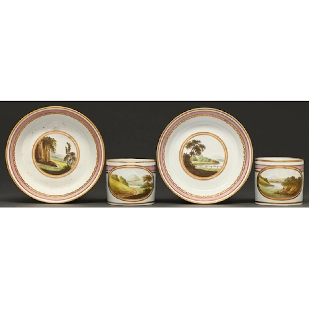A pair of Mansfield decorated coffee cans and saucers, proba...