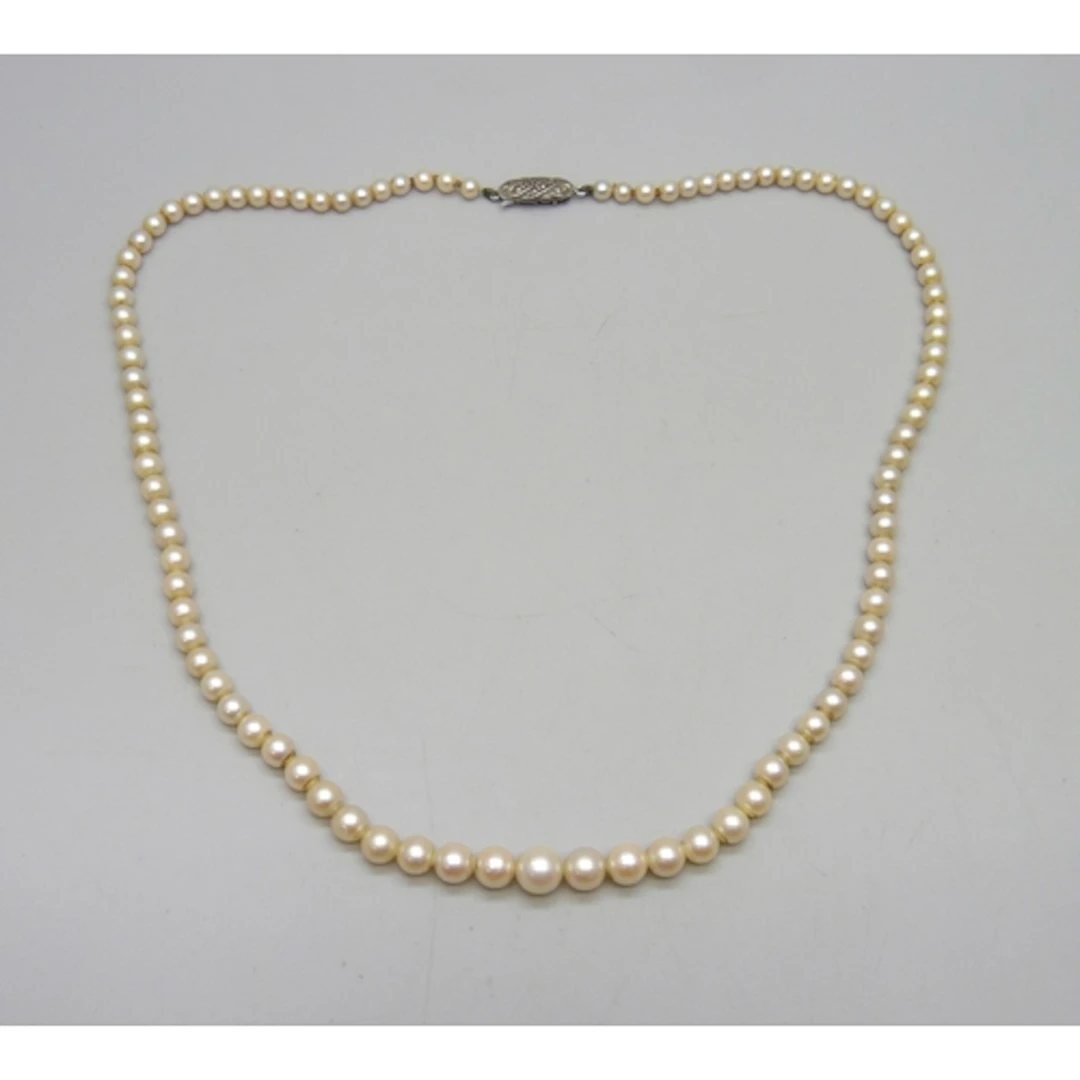 A string of graduated cultured pearls with a silver marcasit...