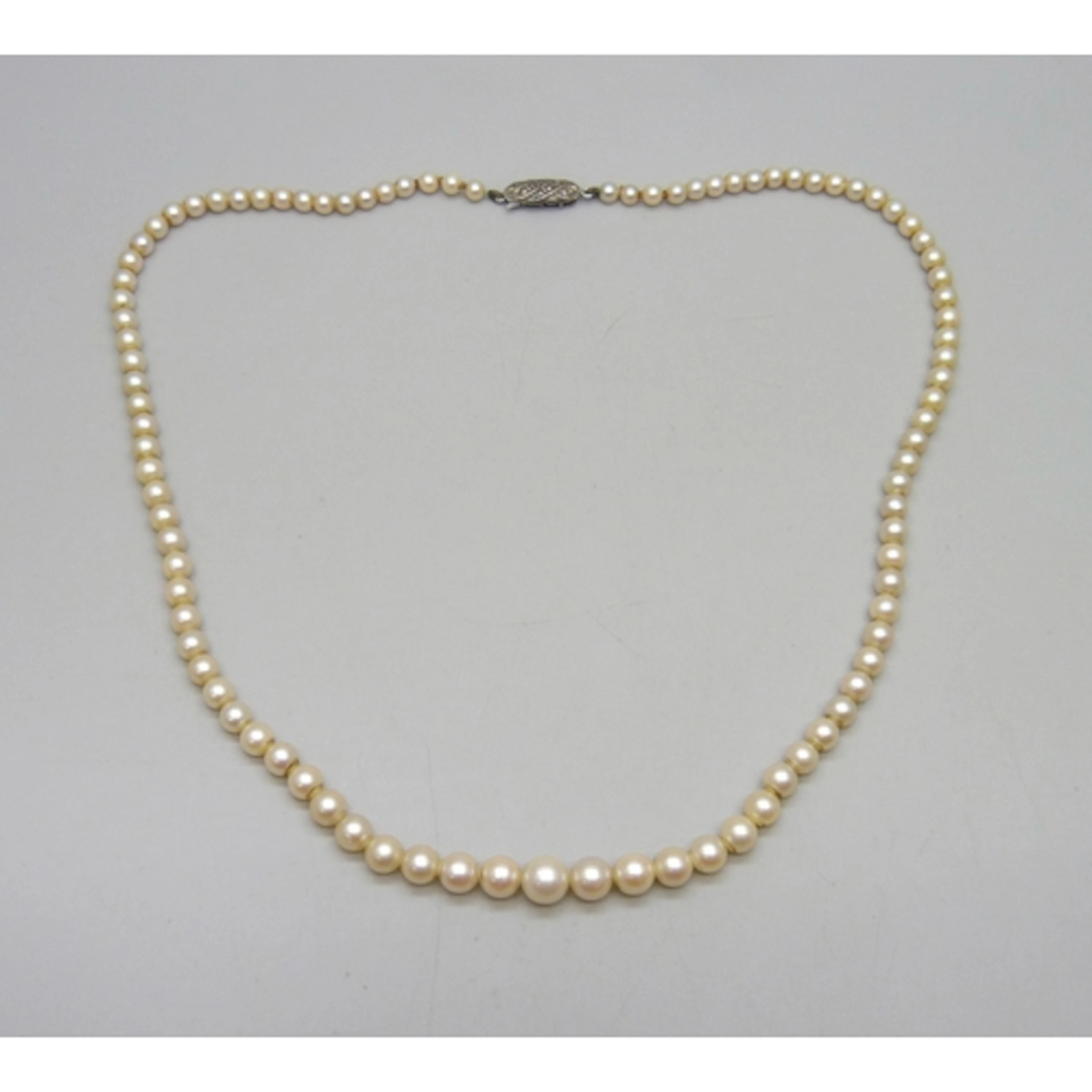 A string of graduated cultured pearls with a silver marcasit...