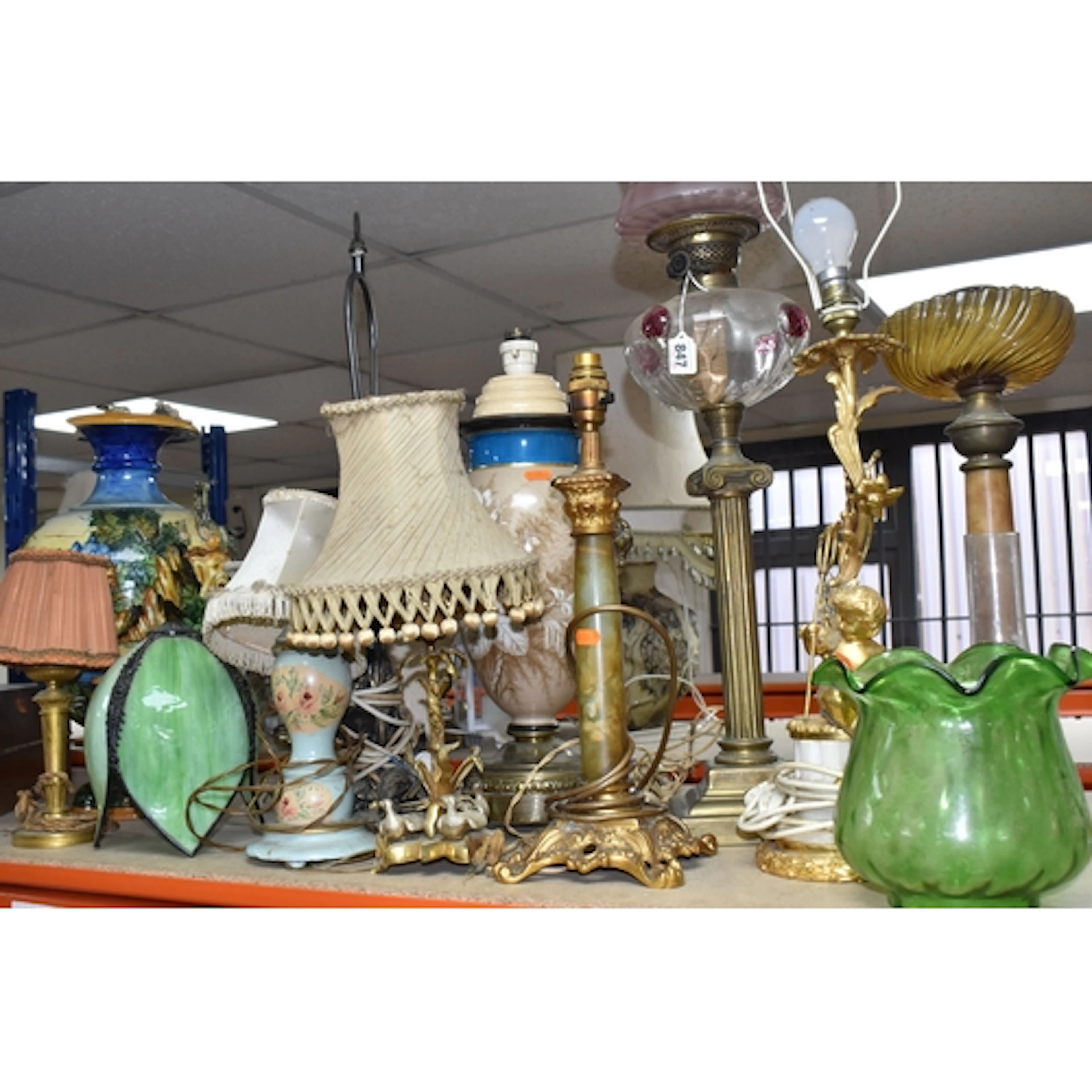 A GROUP OF LAMPS, to include a tall oil lamp, with brass col...