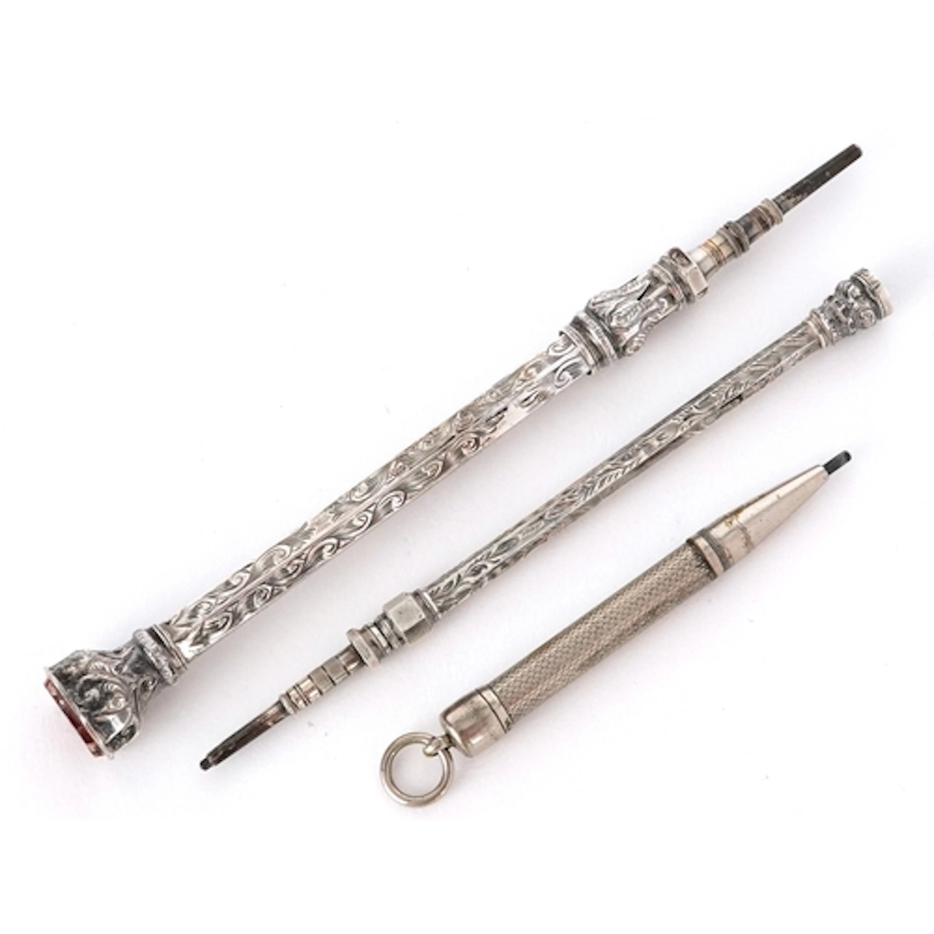 Three Victorian and later silver cased propelling pencils, t...