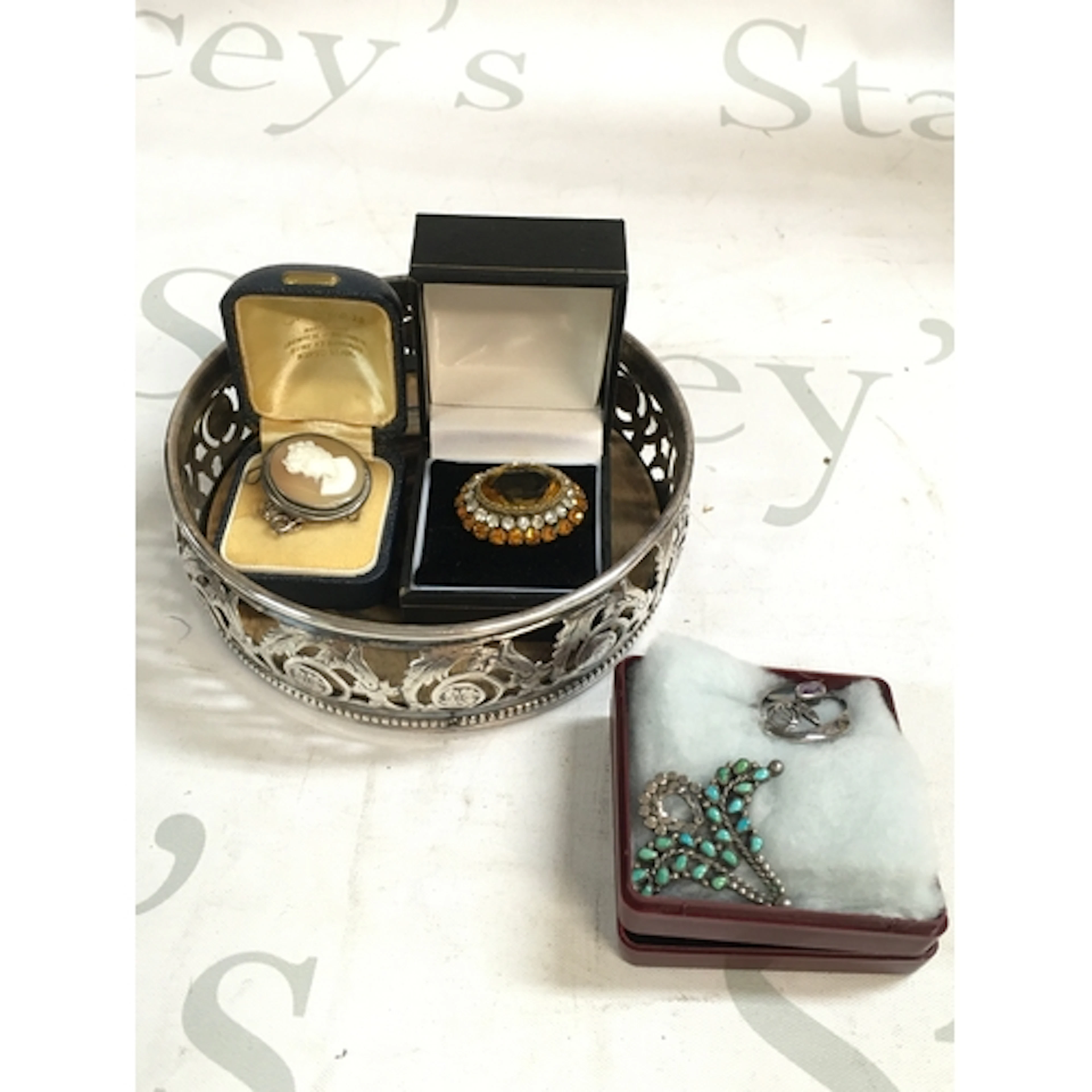 A collection of three broaches and a white metal coaster&nbs...