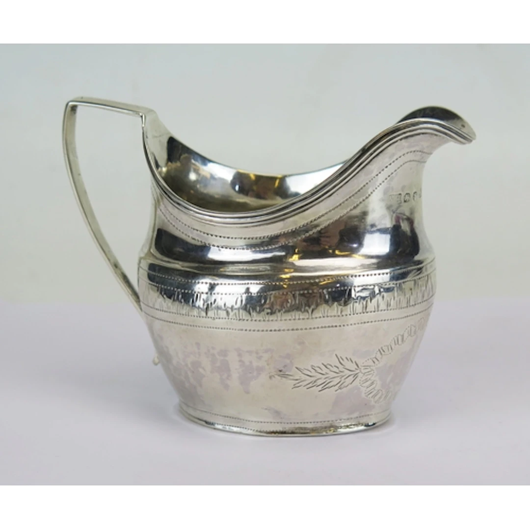 A George III silver cream jug, with stipple border decoratio...