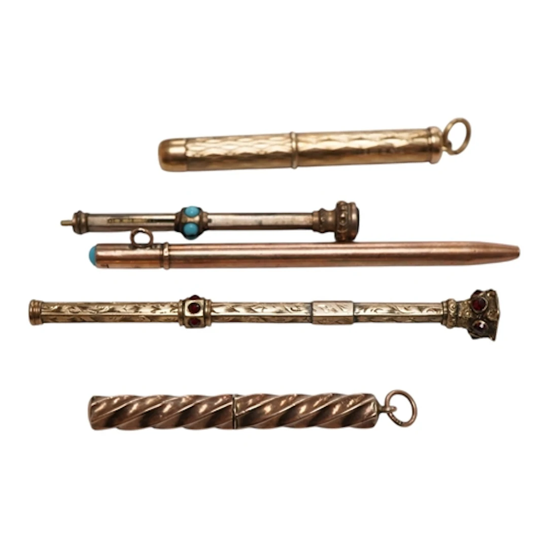 Two yellow metal cased propelling tooth pick, including engr...