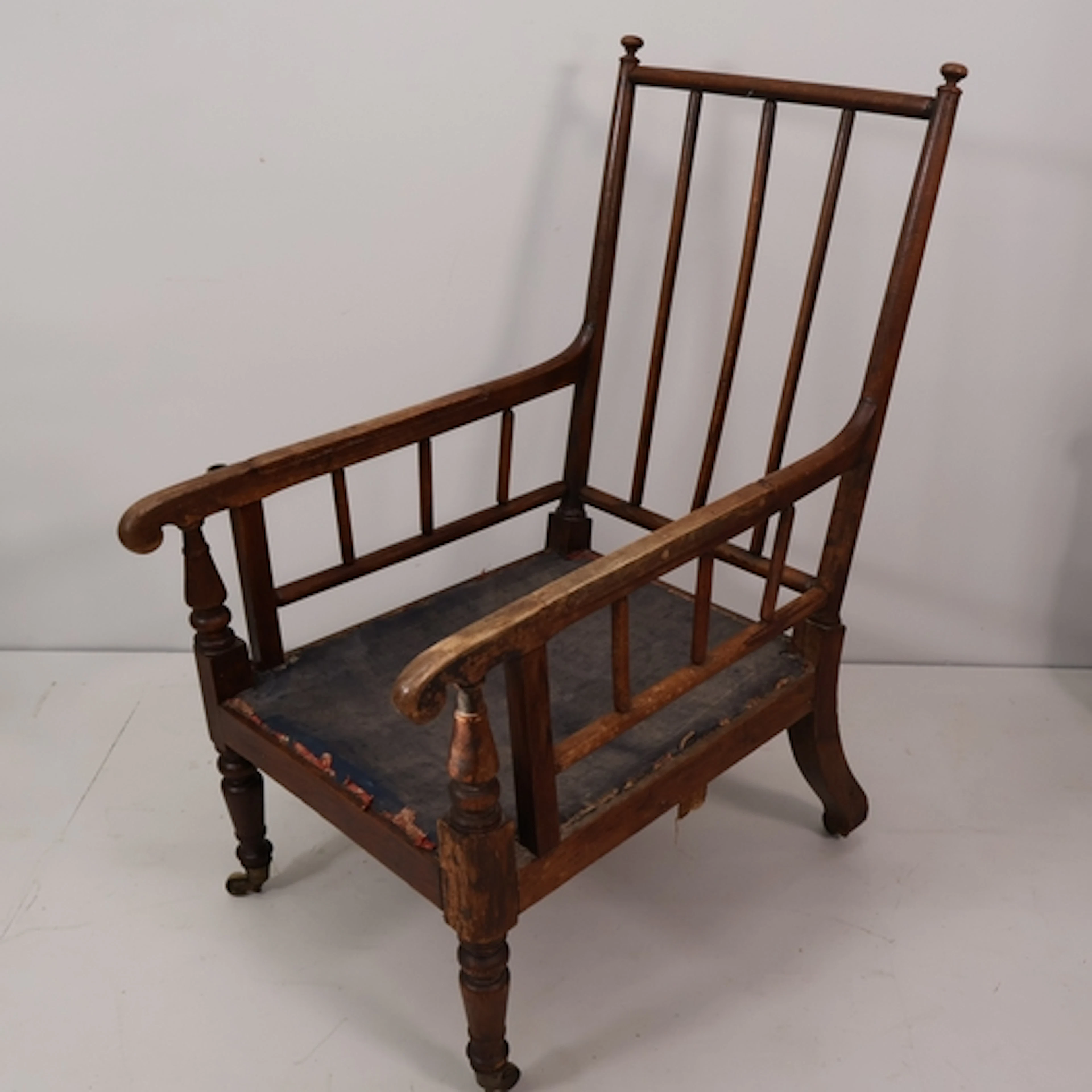 A Regency period stick and rail back library lounge chair in...