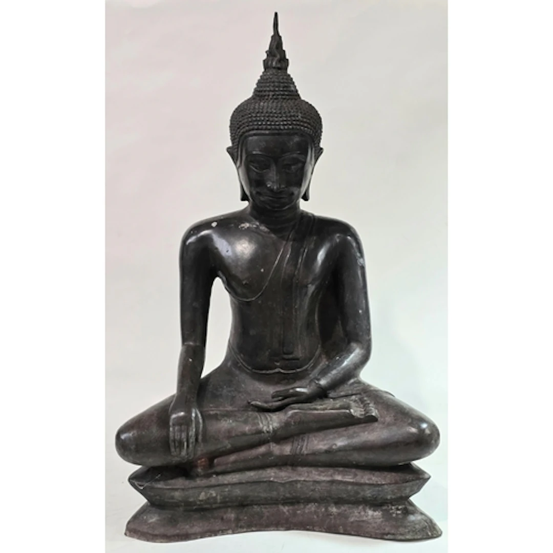 An antique heavy dark bronze seated Buddha sculpture depicte...