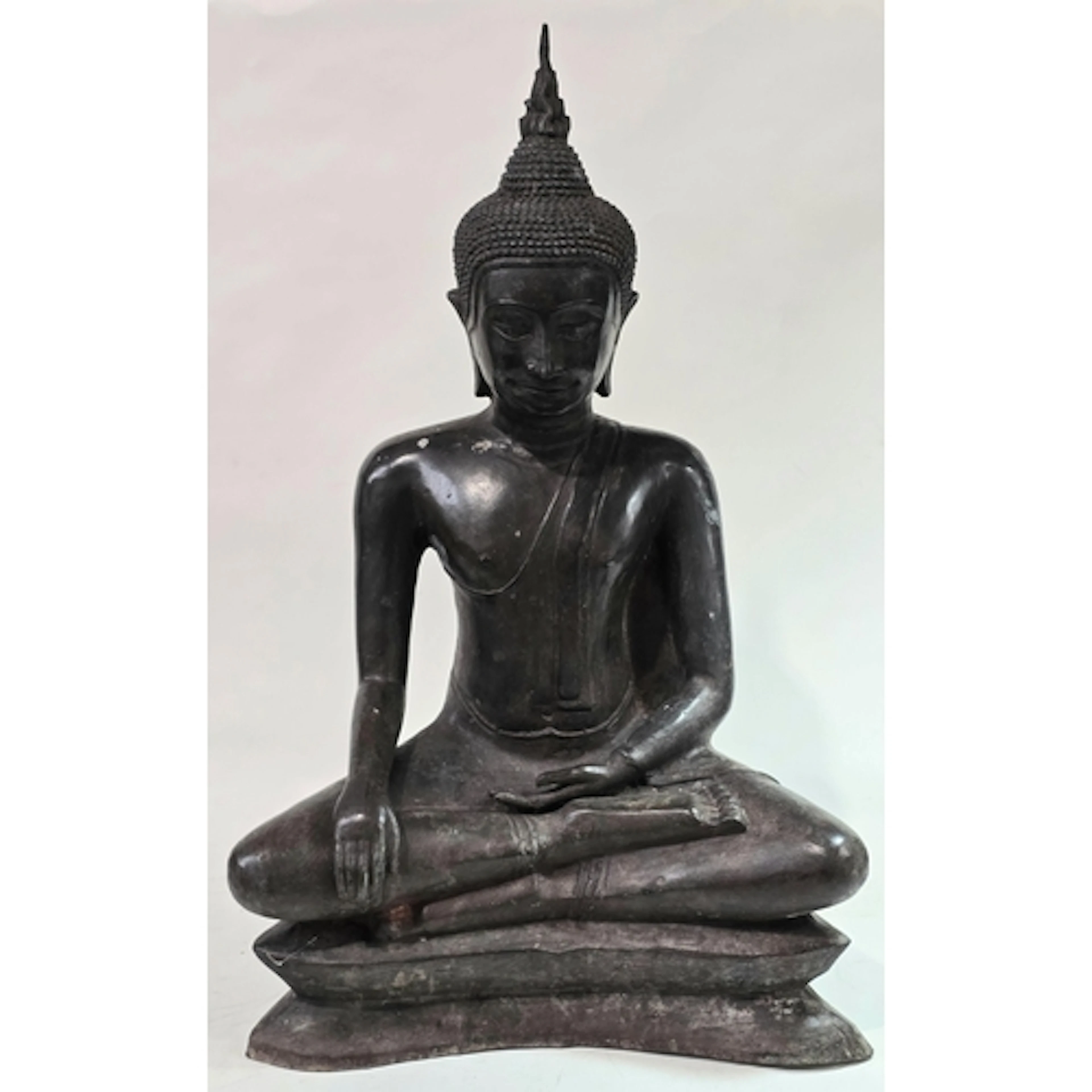 An antique heavy dark bronze seated Buddha sculpture depicte...