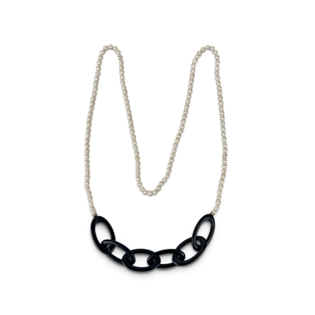 A LONG BAROQUE PEARL NECKLACE WITH INTERLACED OVAL BLACK CEN...