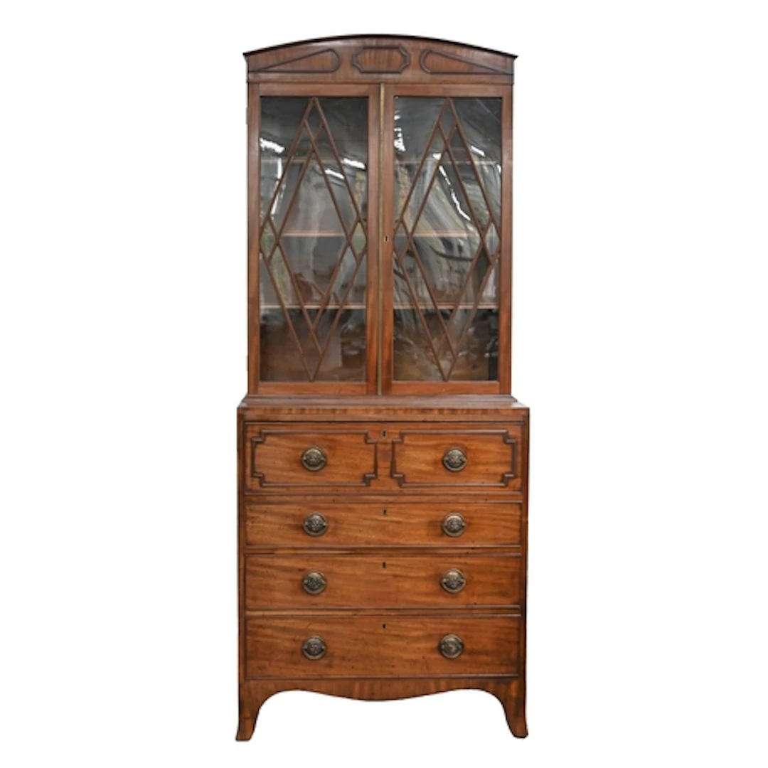 A George III mahogany secretaire bookcase, the low arched pe...