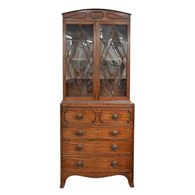 A George III mahogany secretaire bookcase, the low arched pe...