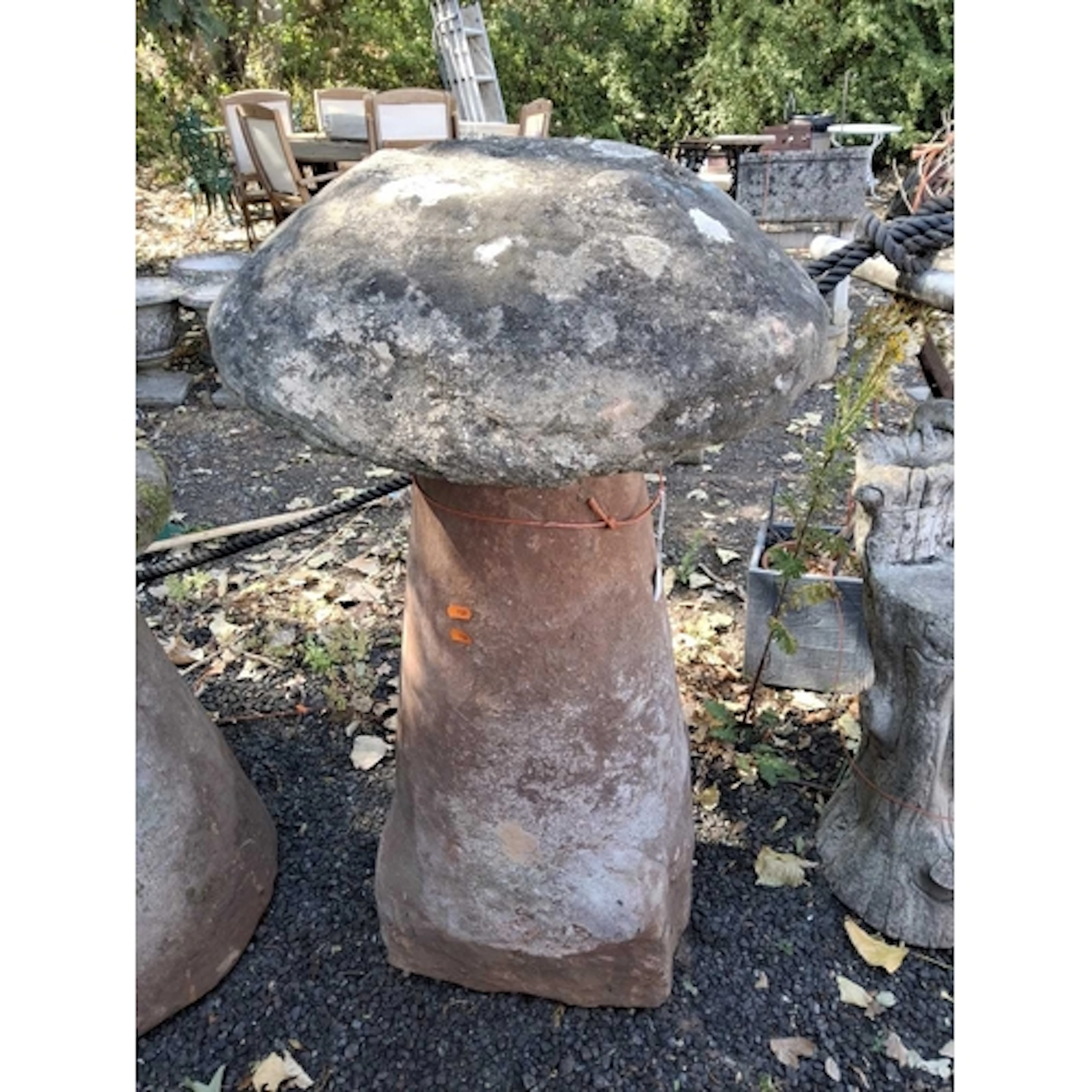 A TALL RED SANDSTONE STADDLE STONE, the top appears to be ma...