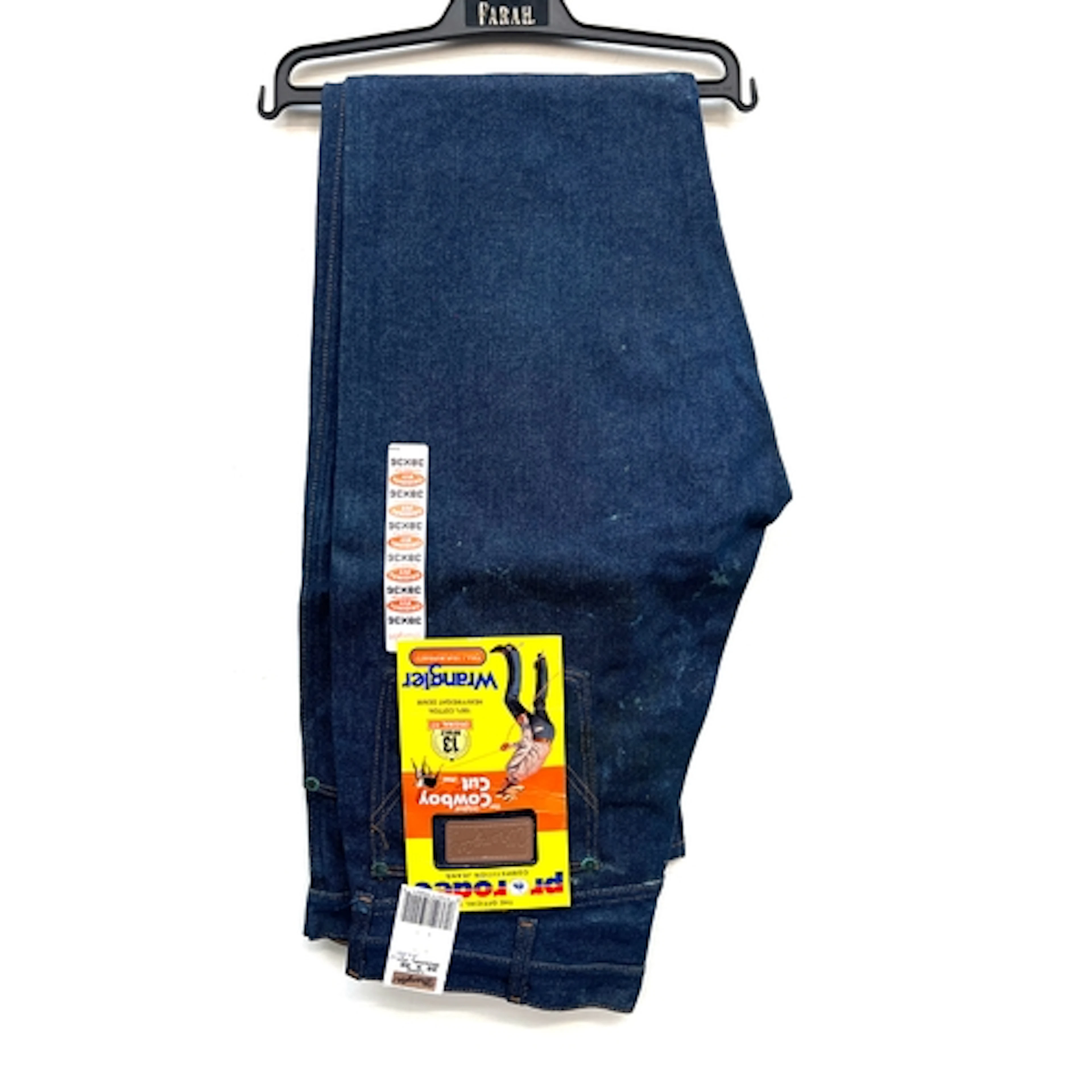A pair of vintage Wrangler cowboy cut jeans with original la...