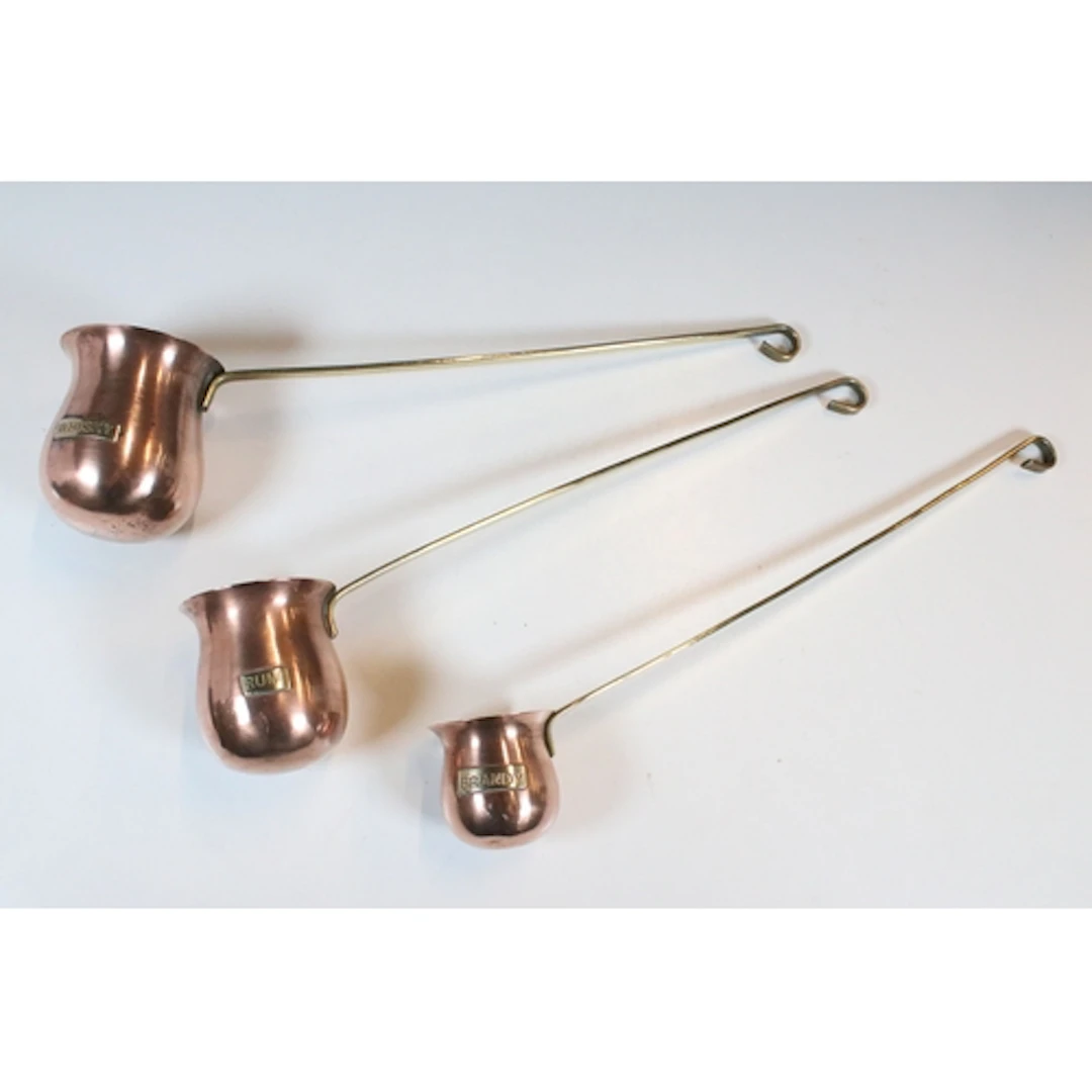 Three copper hanging graduated spirit measures - Whisky, Rum...