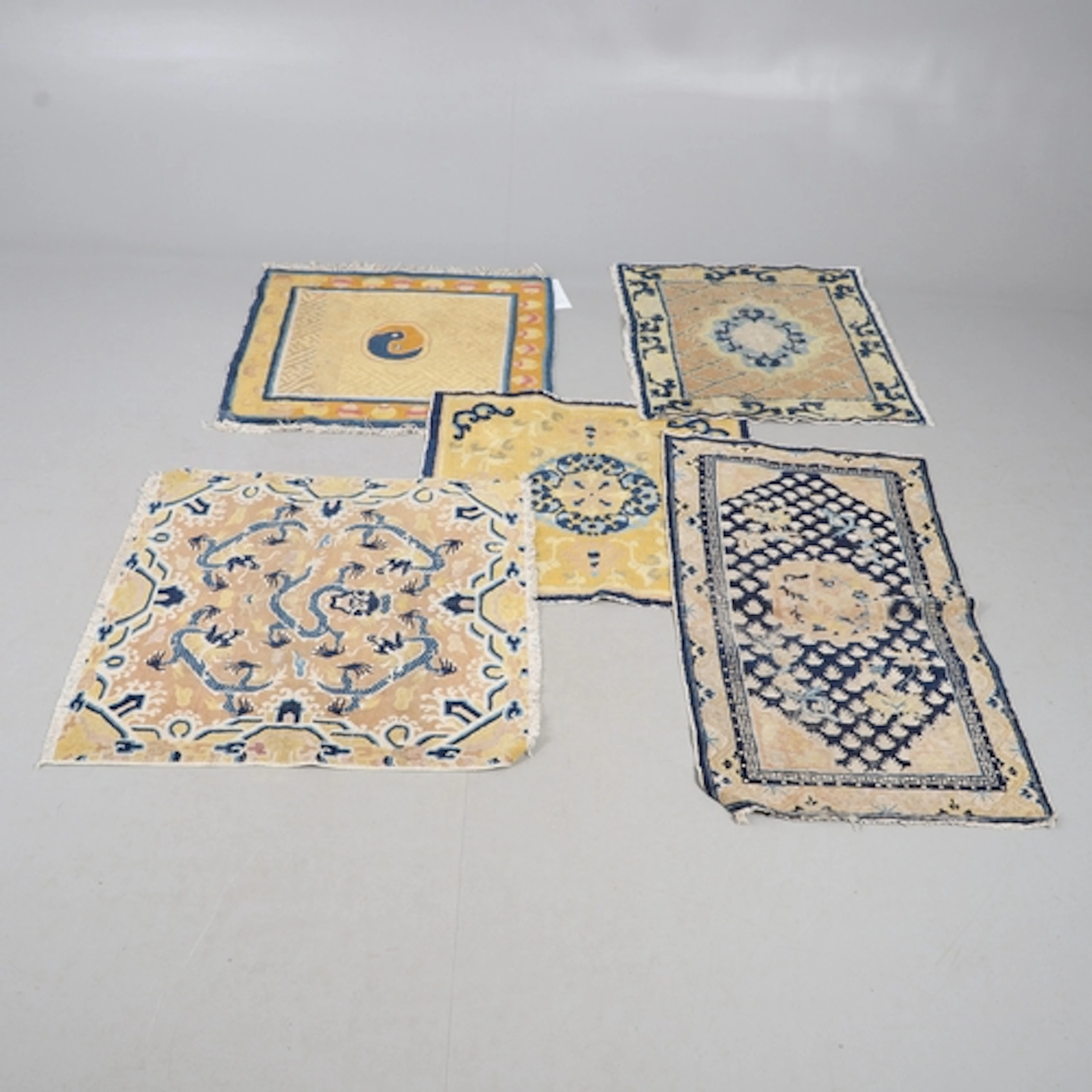 CHINESE RUG. The yellow gold field centred by a dragon surro...