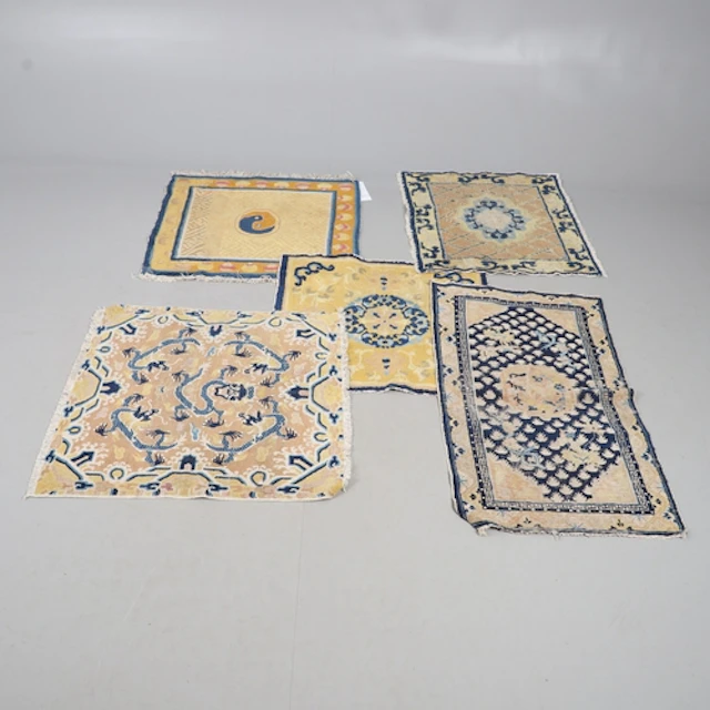 CHINESE RUG. The yellow gold field centred by a dragon surro...