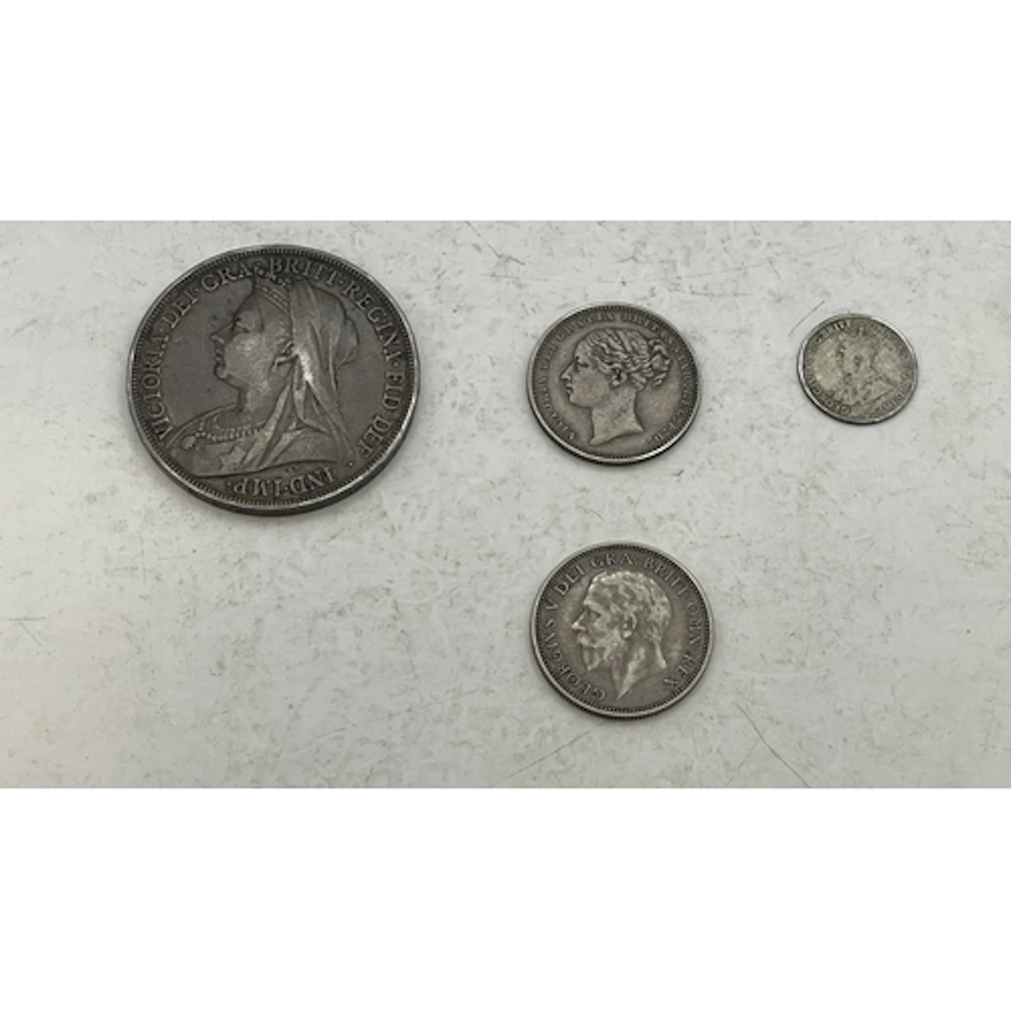 A collection of silver coins. To include an 1894 Crown, an ...