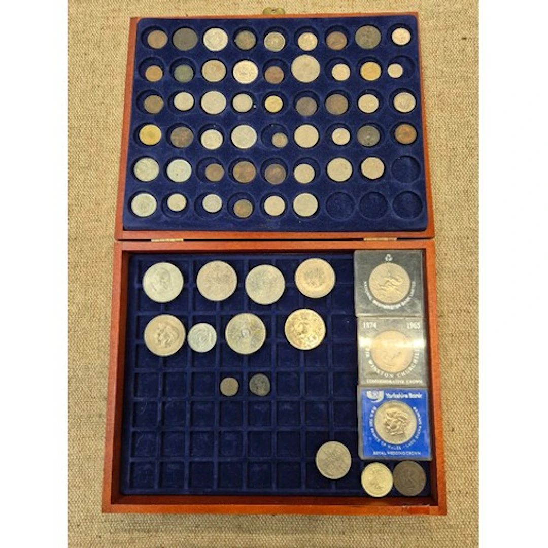A coin presentation box containing various worls coins to in...