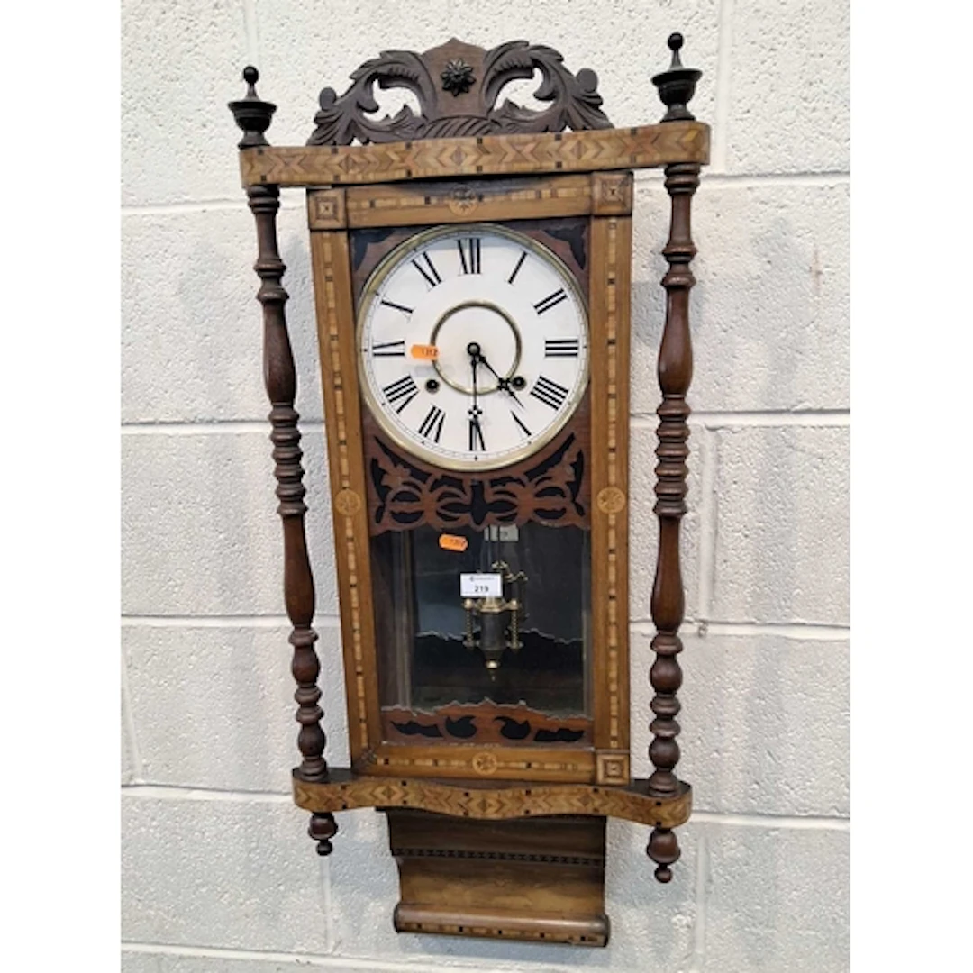 A WALNUT AND PARQUETRY WALL CLOCK, the glass door enclosing ...