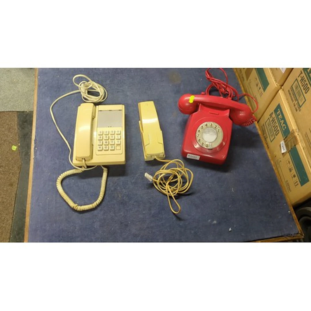 Three vintage telephones: a red rotary-dial desk model with ...